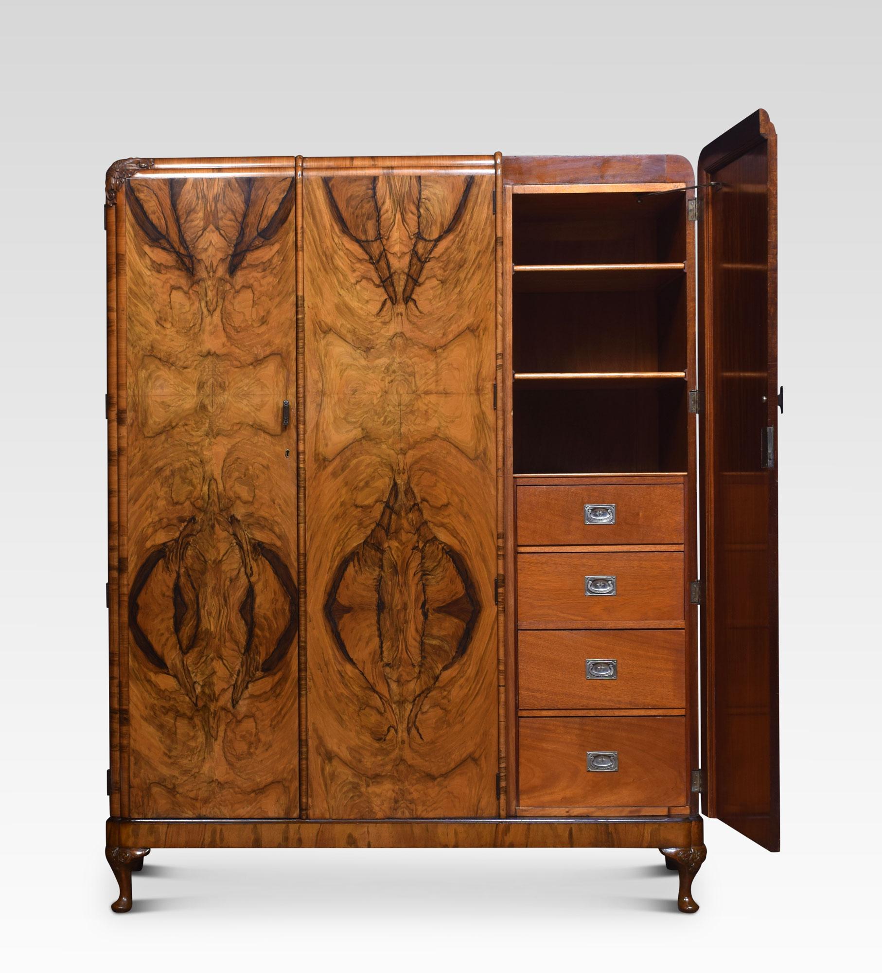 Walnut three-door combination wardrobe, the moulded top above three long panelled burr walnut doors opening to reveal the large hanging area to one side the other fitted with sliding trays and draws. All raised up on cabriole