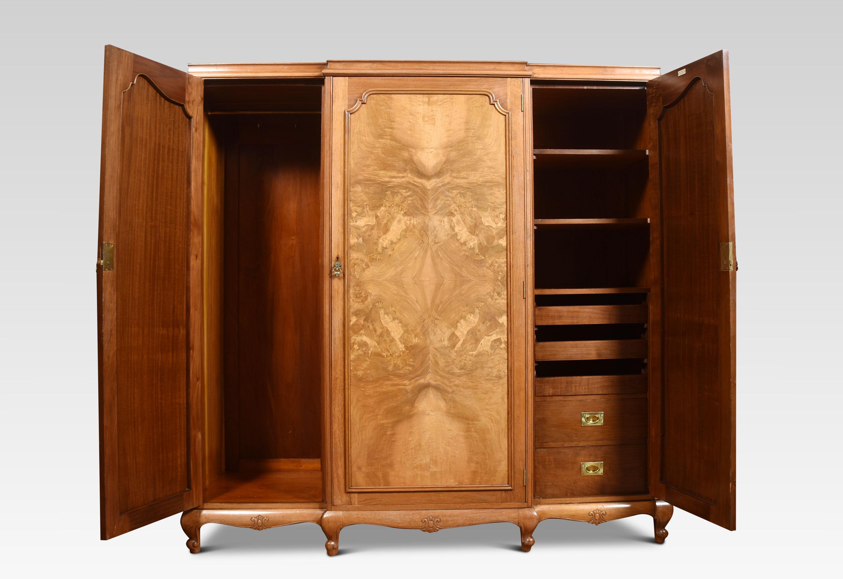 Walnut three-door combination wardrobe, the molded top above three long paneled walnut doors opening to reveal the large hanging area to one side the other fitted with sliding trays and drawers. All raised up on cabriole legs.
Dimensions
Height 73