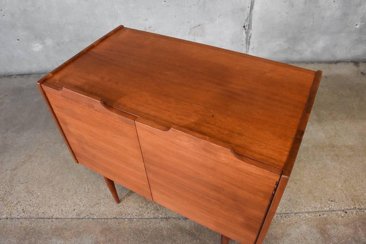 A three-drawer dresser from the 'Today' collection designed by John Caldwell for Brown Saltman in 1965. This uncommon piece features a distinctive design and very high quality construction utilizing solid walnut and walnut veneer throughout, with