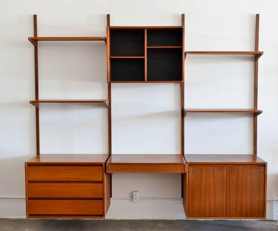 Walnut three wall unit by Barzilay, circa 1970. Beautiful walnut with aluminium accent wall unit or shelving unit by Barzilay of Los Angeles. High quality walnut with aluminium shelving detail. Easily attaches to wall. Price includes All Cabinets