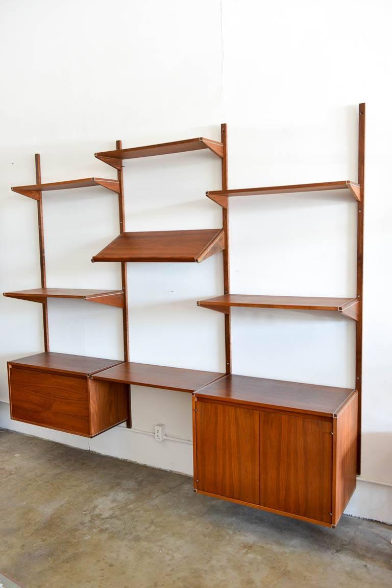 Walnut three wall unit by Barzilay, circa 1970. Beautiful walnut with aluminium accent wall unit or shelving unit by Barzilay of Los Angeles. High quality walnut with aluminium shelving detail. Easily attaches to wall. Price includes All Cabinets