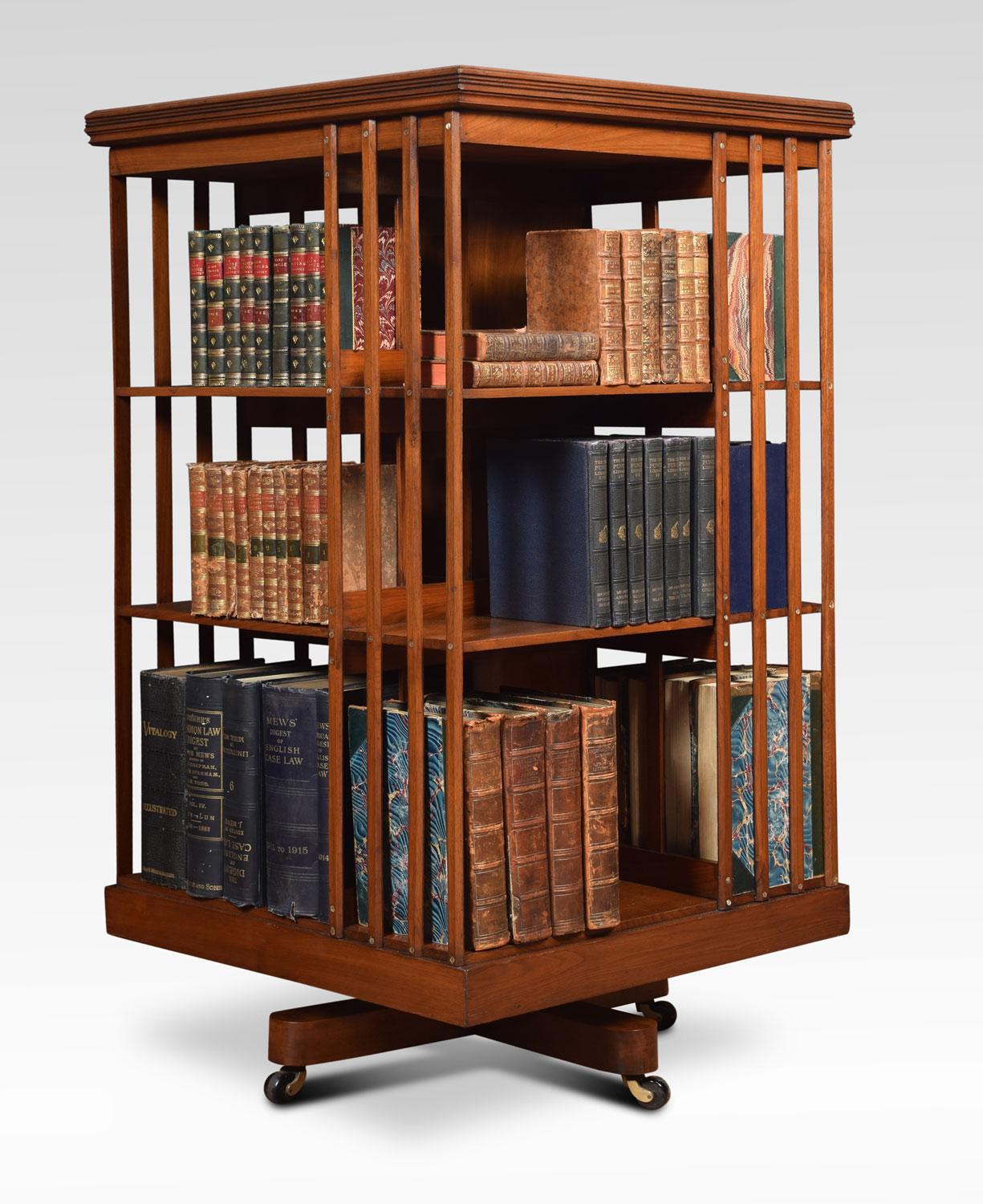 Large walnut three-tier revolving bookcase, the square moulded top above an arrangement off shelves raised up on cruciform base with brass caps and ceramic castors.
Dimensions:
Height 45 inches
Width 23.5 inches
Depth 23.5 inches.
