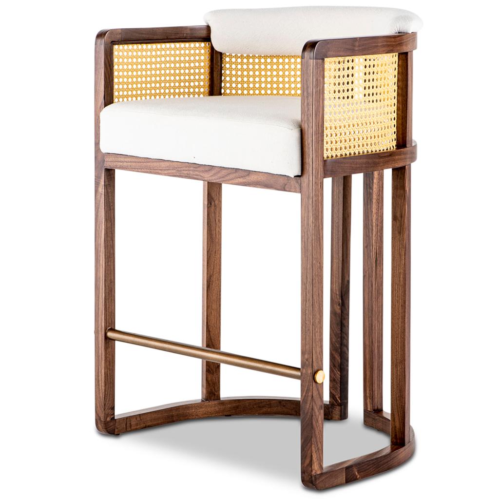 The Livingston bar stool is part of the Tala collection designed by Egg Designs and manufactured in South Africa.
This modern style bar stool has a solid walnut timber frame inset with woven mesh rattan, finished with an off white linen upholstery