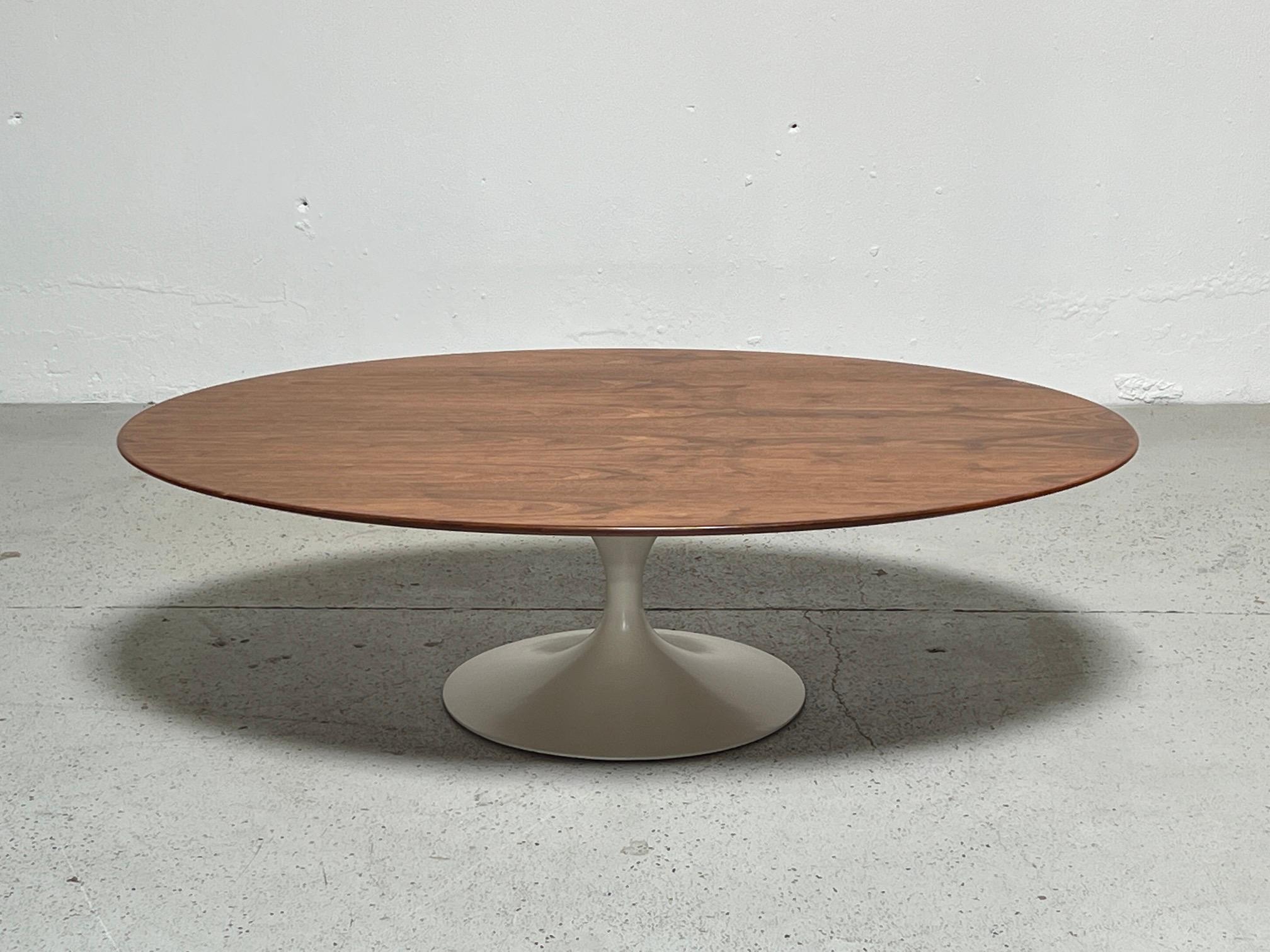 An early walnut topped tulip coffee table designed by Eero Saarinen for Knoll.
