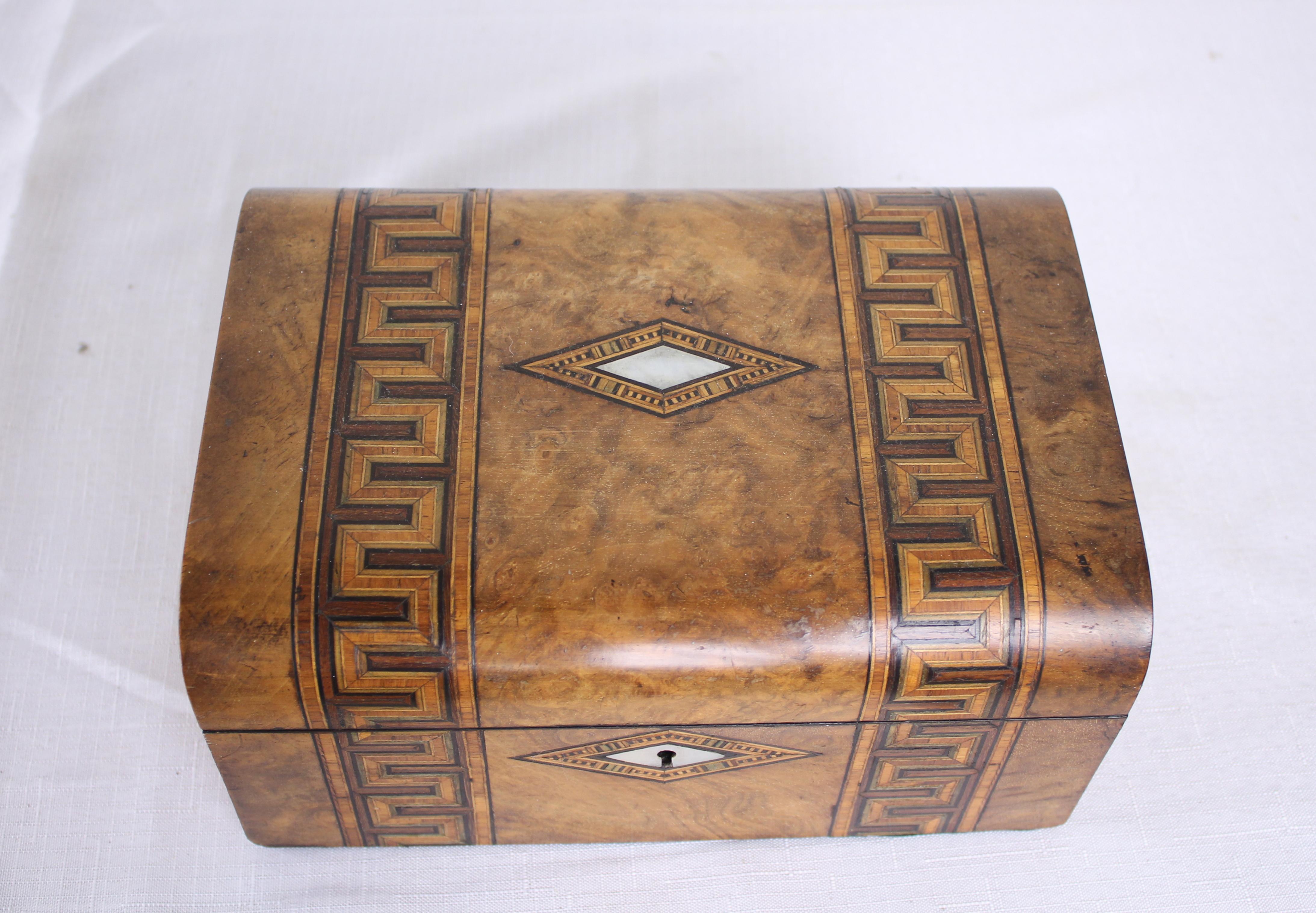 A decorative walnut Tumbridgeware jewelry box with vibrant violet silk interior. Tumbridgeware being characterized as a form of decoratively inlaid woodwork, typically in the form of boxes, that is characteristic of Tumbridge and the spa town of