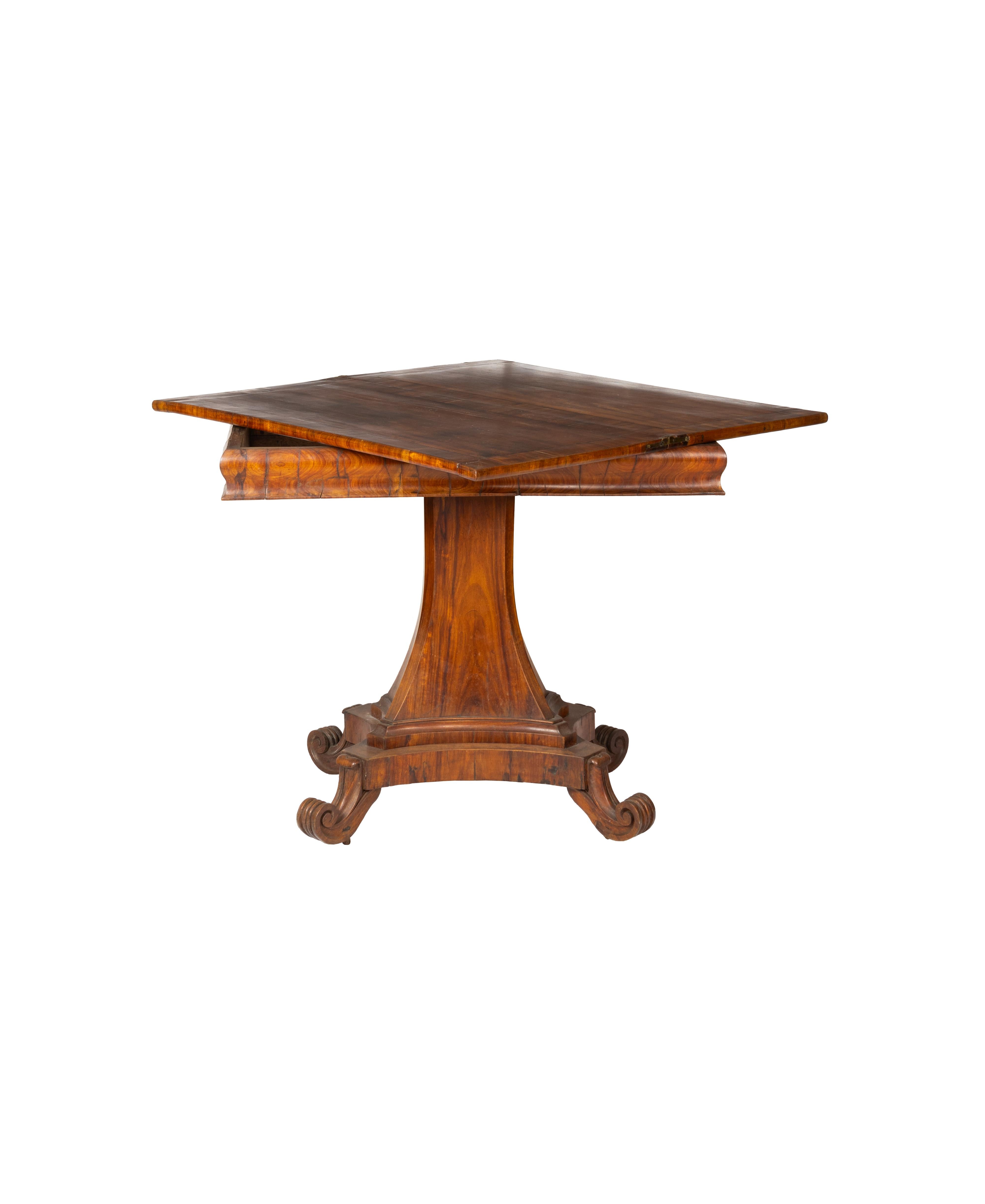 A superb 19th century walnut card table featuring a hinged and molded rectangular top that elegantly unfolds to double in size, revealing a finely hand-carved wooden playing surface.

This Georgian English table was designed with both beauty and