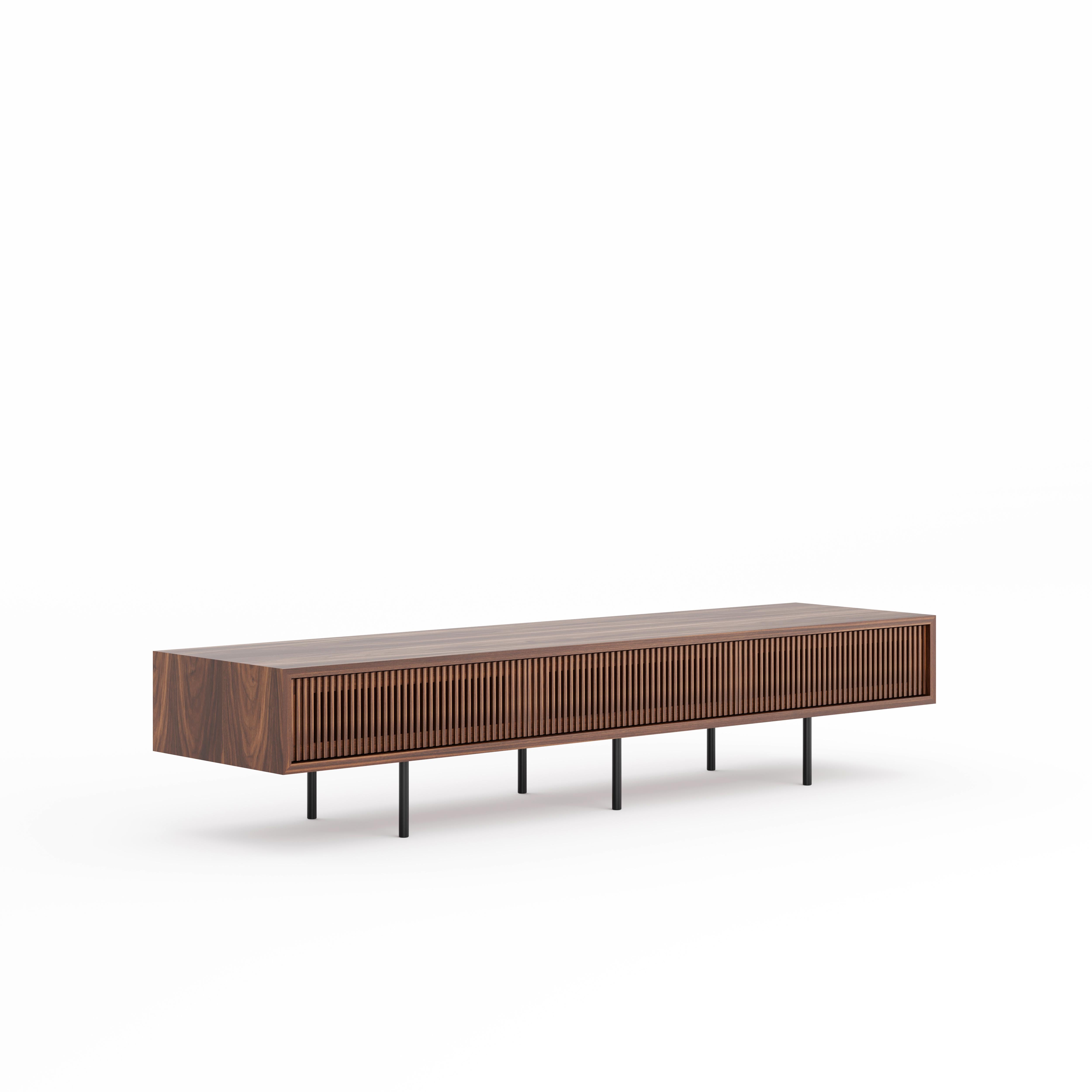 Nussbaum-Lowboard mit drei Lattentüren und schlichten schwarzen Aluminiumbeinen im modernen Stil der Jahrhundertmitte.
Perfekt als TV-Ständer oder Medienkonsole für Musikliebhaber. Viel Stauraum zur Unterbringung von Mediengeräten und