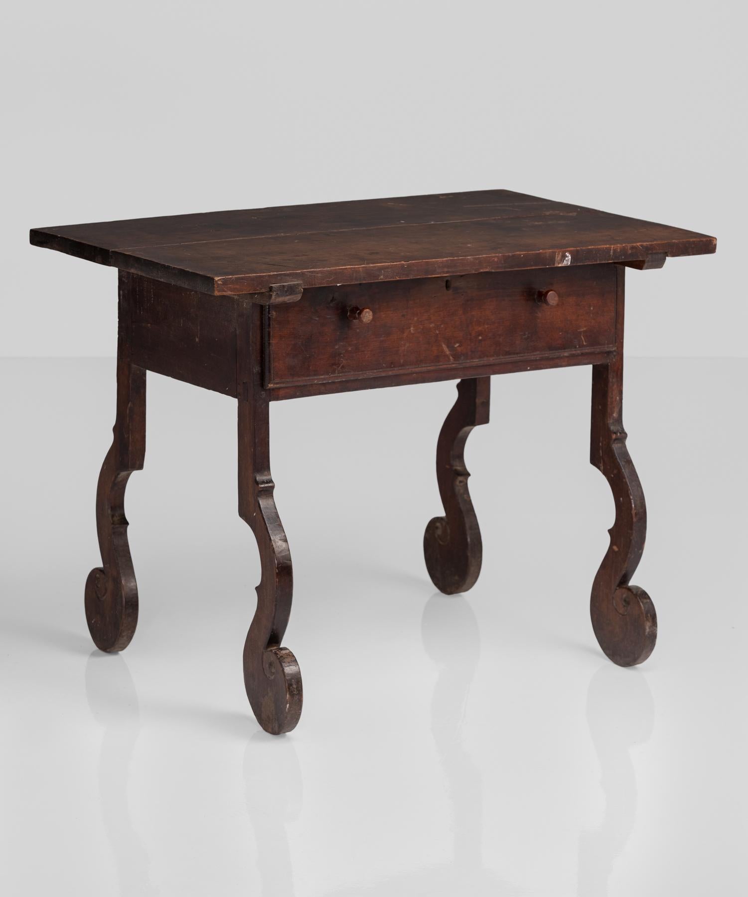 Unusual tall walnut side table or desk, Italy, circa 1790.

Elegant form with unique detailing includes wonderfully playful legs with feet that curl upwards.