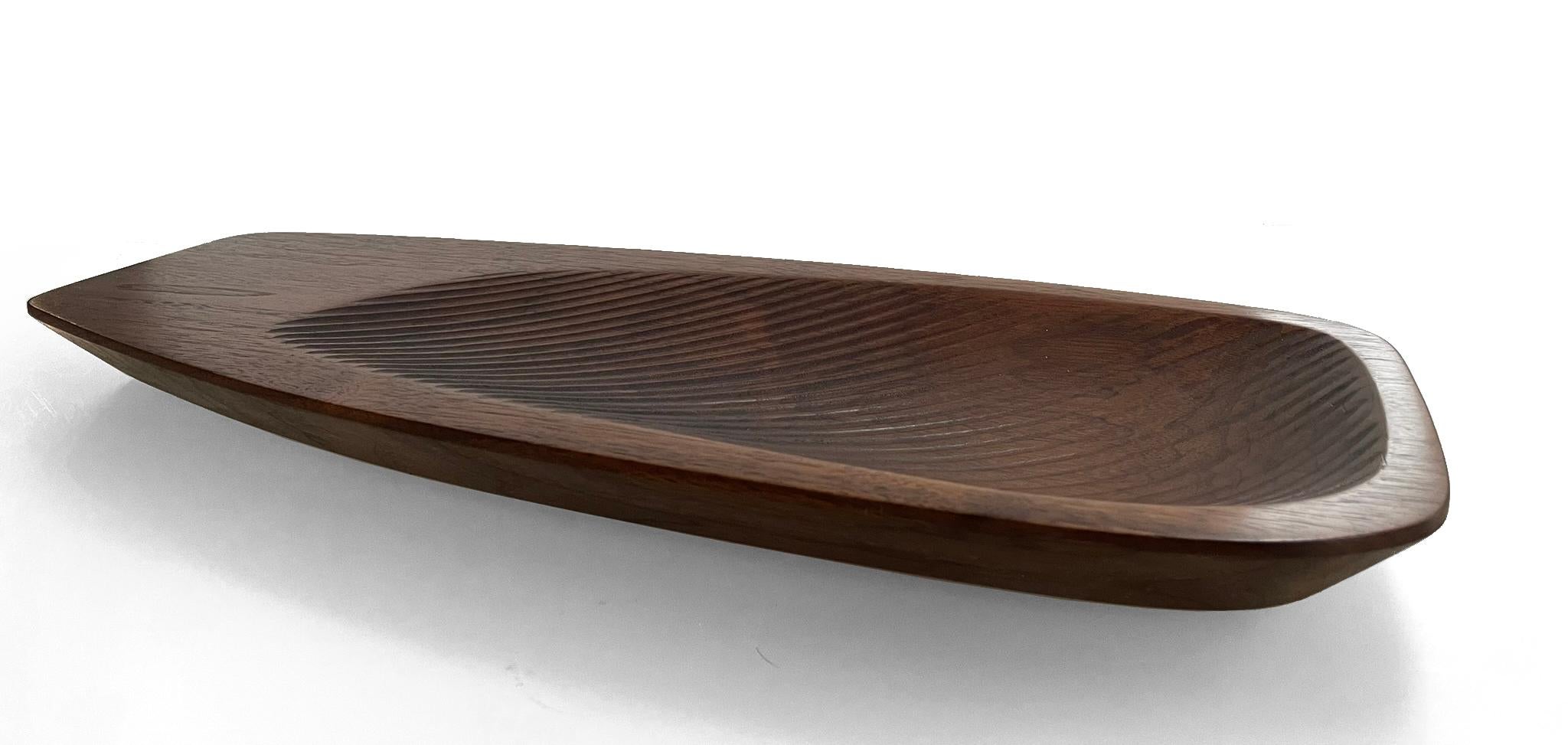 This decorative walnut bowl can function as a valet tray or table centerpiece. The Valas is named after the Finnish word for 