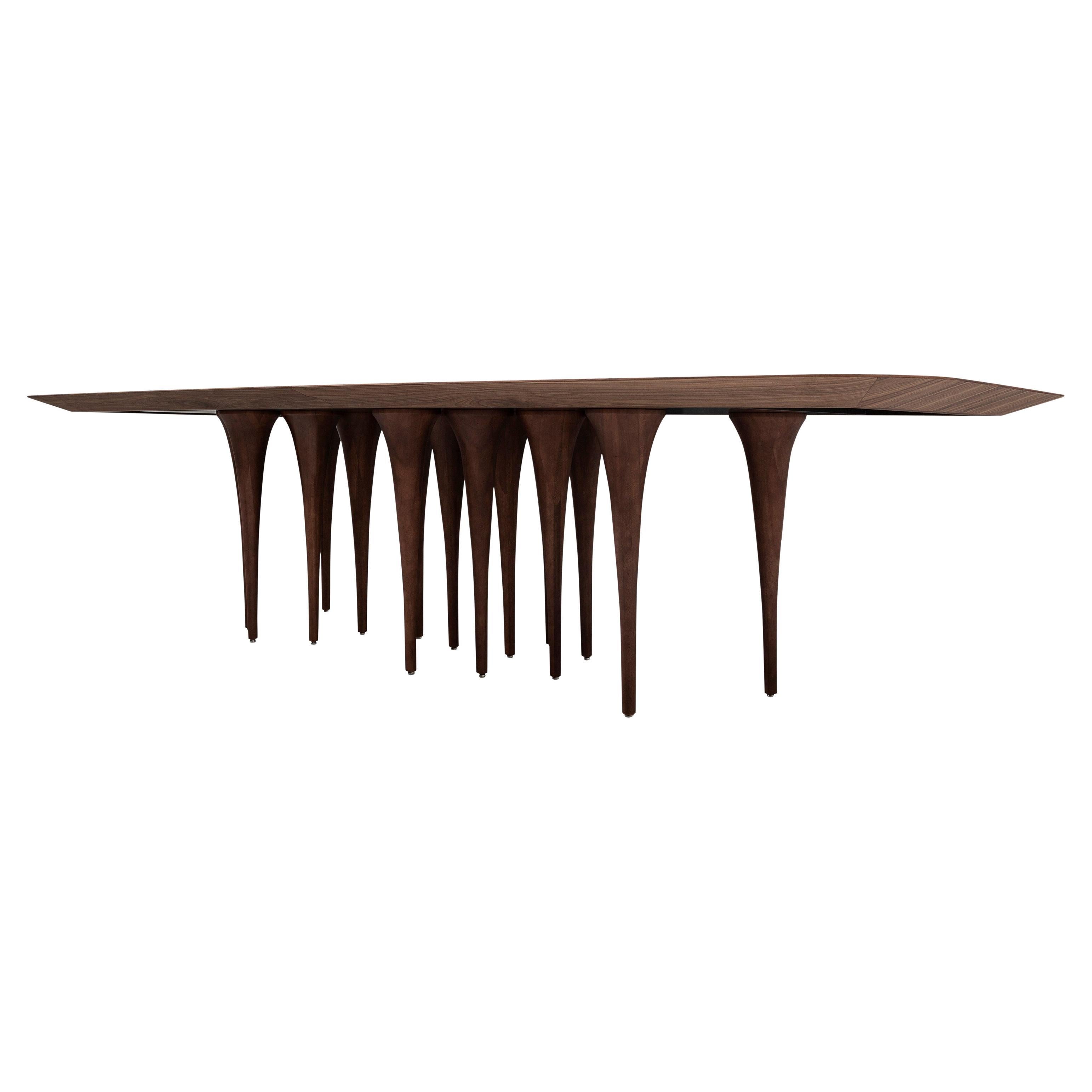 Architectural and dramatic, the Pin dining table by Uultis is a bold centerpiece defined by its sculptural silhouette and meticulously crafted detailing. Featuring a generously sized 118-inch walnut wood veneered top with dovetail detailing in its