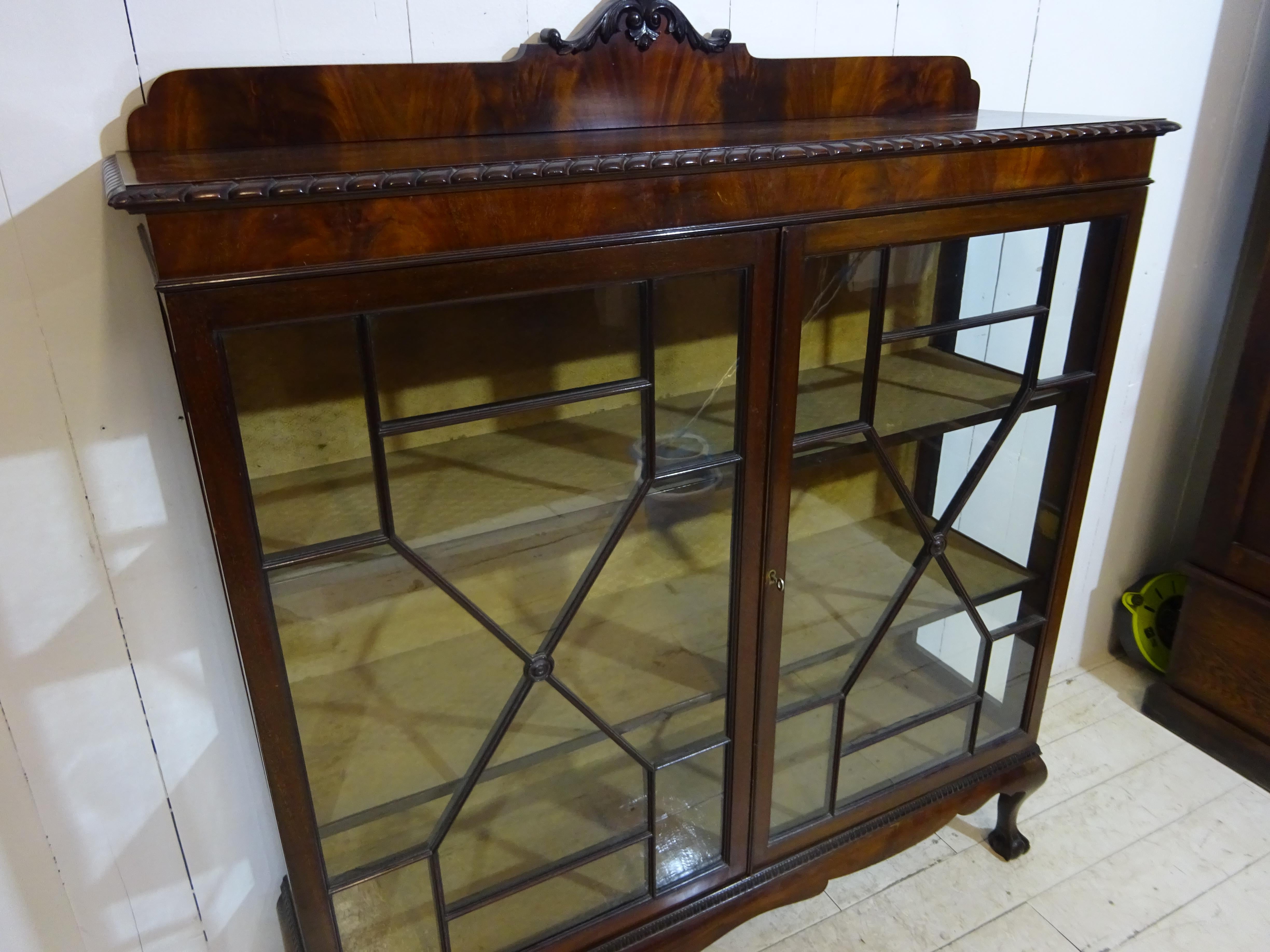 This is a stunning late Victorian display cabinet.

In lovely original condition the cabinet has been handcrafted throughout. The display cabinet sits on four hand carved ball and claw feet offering a stable and secure standing position. Above is