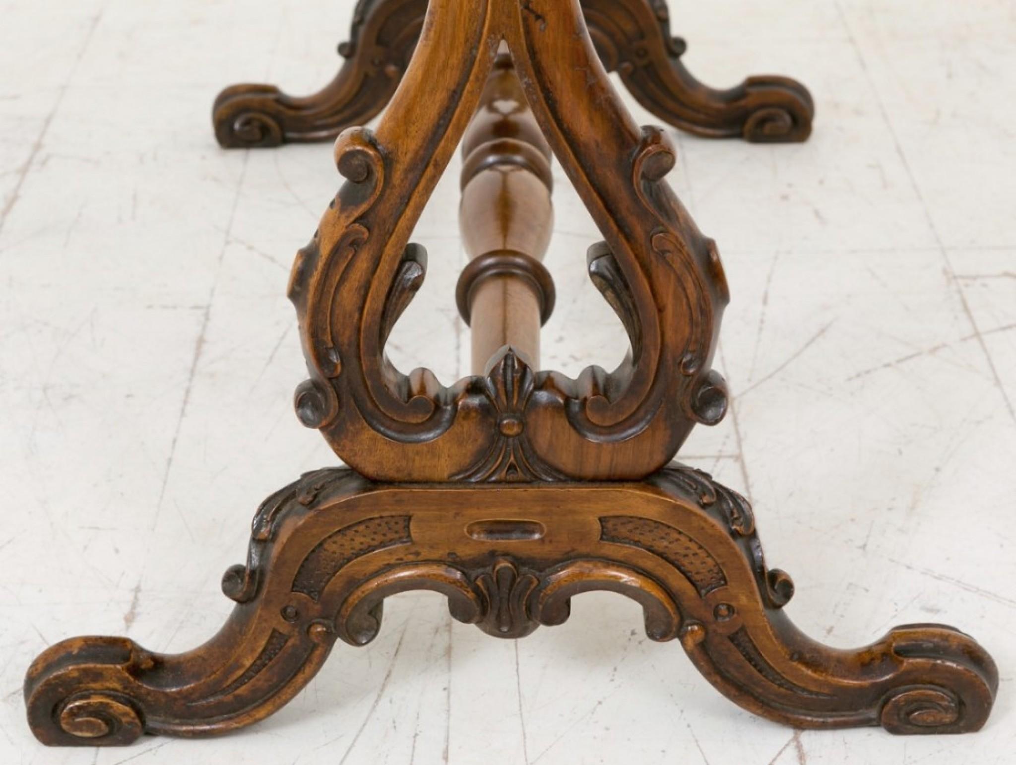 A superior quality Victorian Walnut Stretcher table, standing on swept feet with carved knees and toes.
circa 1860
The Lyre shaped supports featuring carvings and the serpentine top having quartered Burr Walnut veneers.
A very pretty table.
