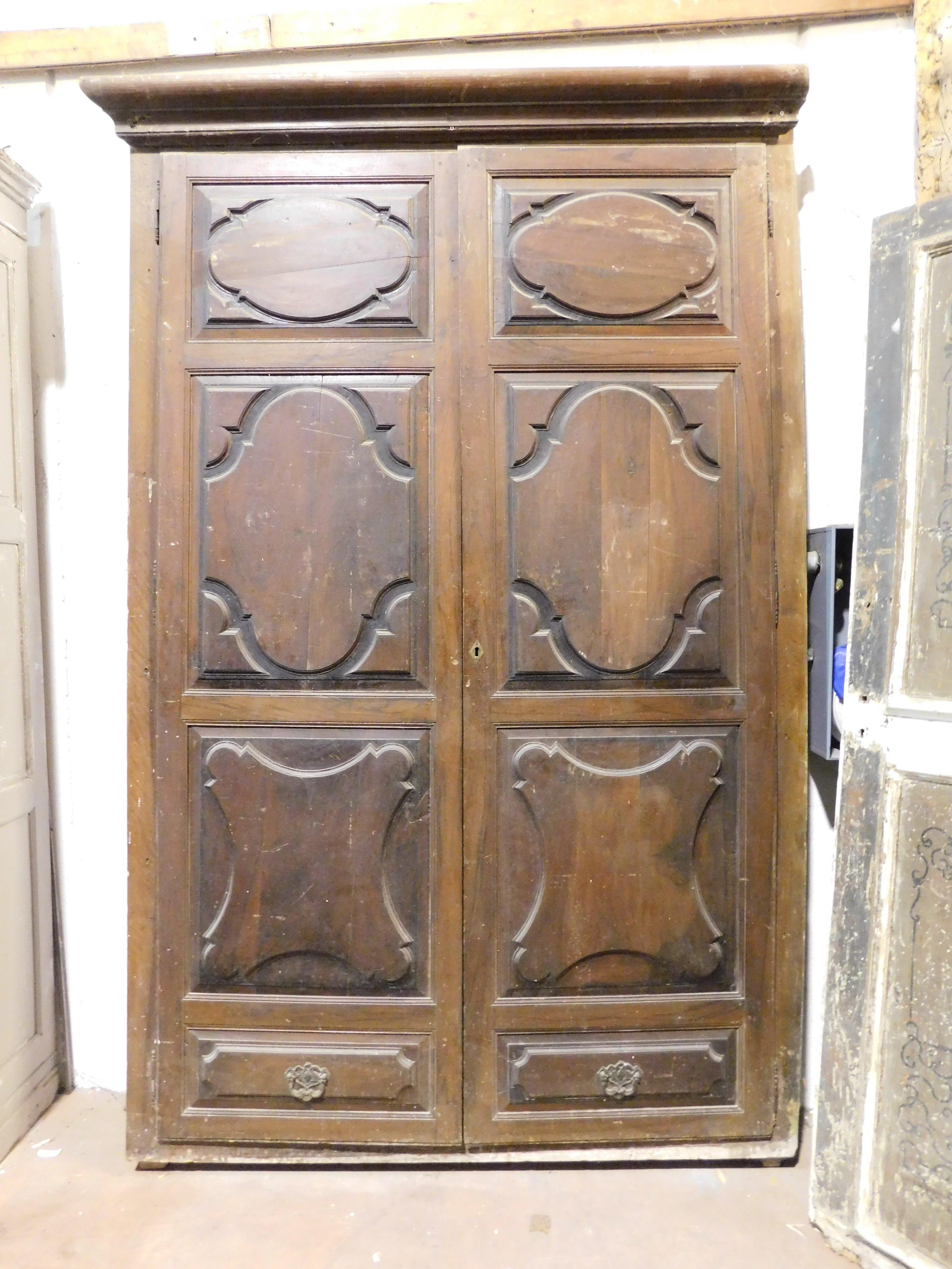 Very old, antique Walnut wall Placard, front of a wardrobe with two carved doors with fake drawers in the lower part, it was the front part of a wardrobe that was then built into the wall, so only the front.
Original from the 17th century, of