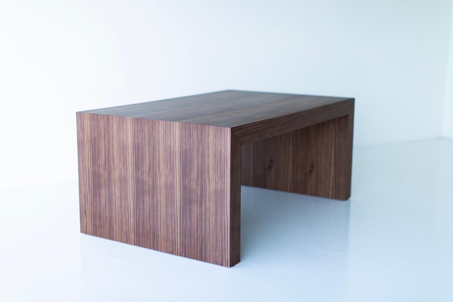 Bertu Coffee Table, Waterfall Coffee Table, Walnut

This Walnut Waterfall Coffee Table is made in the heart of Ohio with locally sourced wood. Each table is hand-made with mitered corners from walnut veneer and finished with a beautiful matte