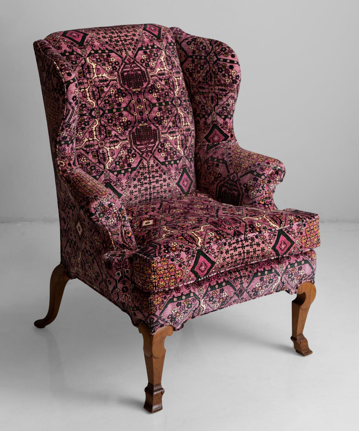 Walnut wing chair in 100% cotton velvet from House of Hackney.

Newly upholstered in patterned velvet fabric, with original carved walnut frame.