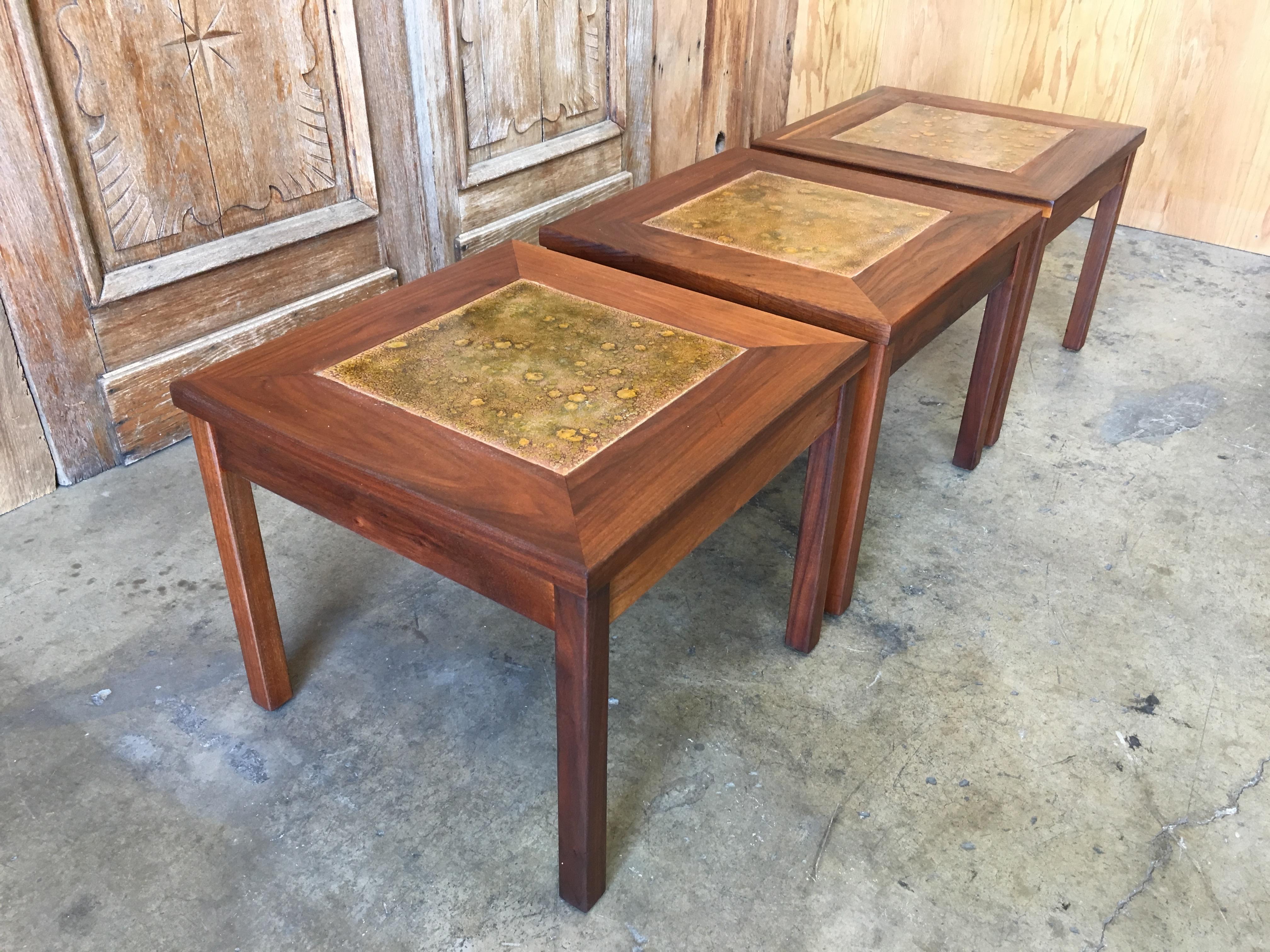 Set of three walnut with copper tile top tables by John Keal for Brown Saltman.
