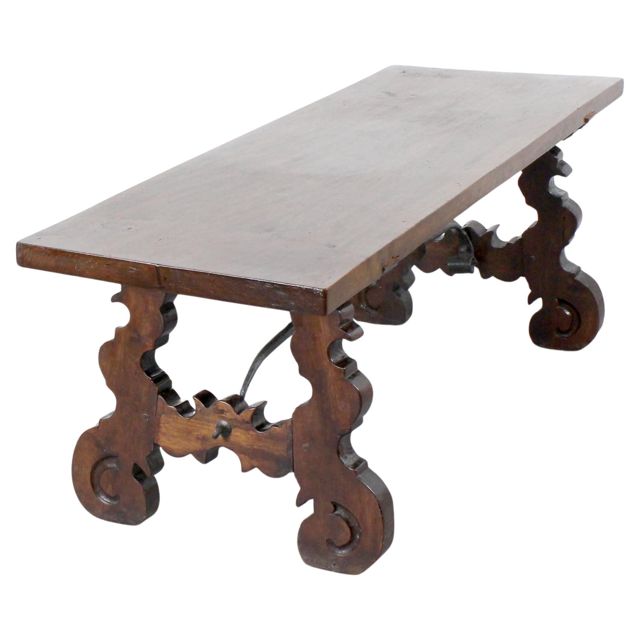 Walnut wood bench with lyre-shaped legs and wrought iron fasteners