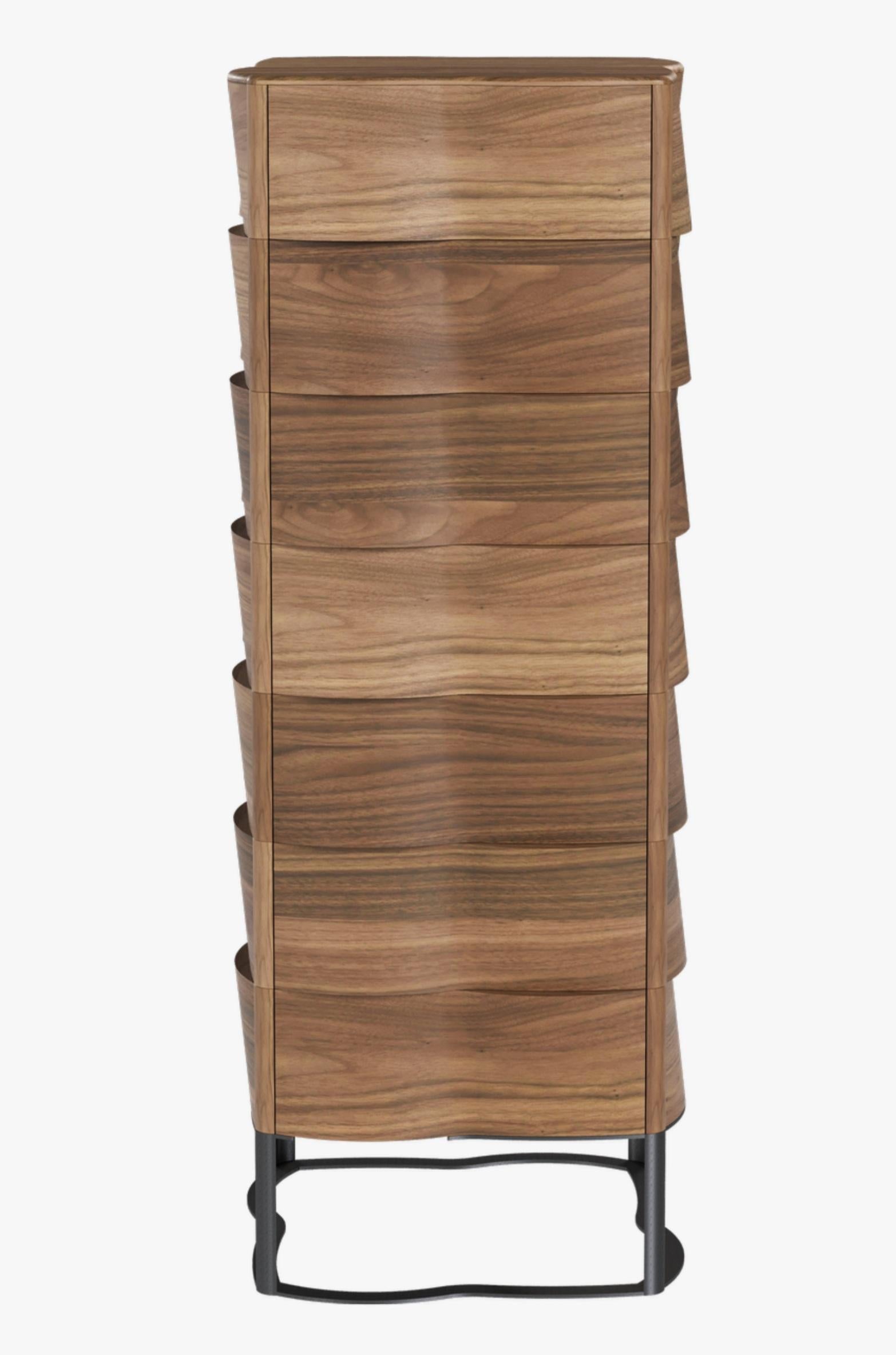 Stunning Sculptural Design creation Walnut chest of drawers with a round shaped silhouette that reveals the wood flexibility and beauty and wakens the desire of feeling its shape by touch.
It stands out for the elegance with which the combination