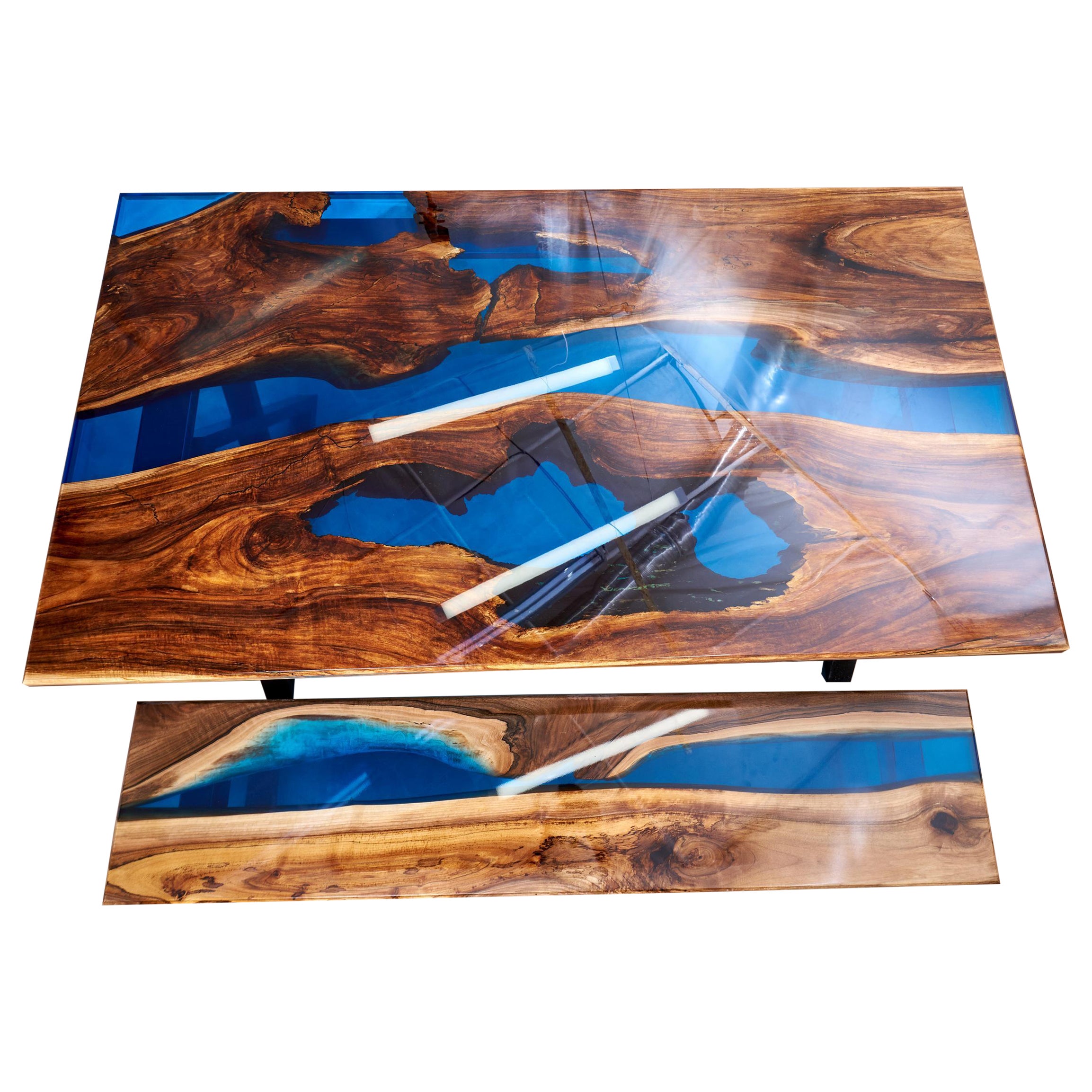 When I made this table, the main challenge was to find really old walnut slabs. So that they would be dark, with a rich dark vein, a little rotten and with lots of holes and cracks. The resin color had to be a clear blue and it's cool to find wood