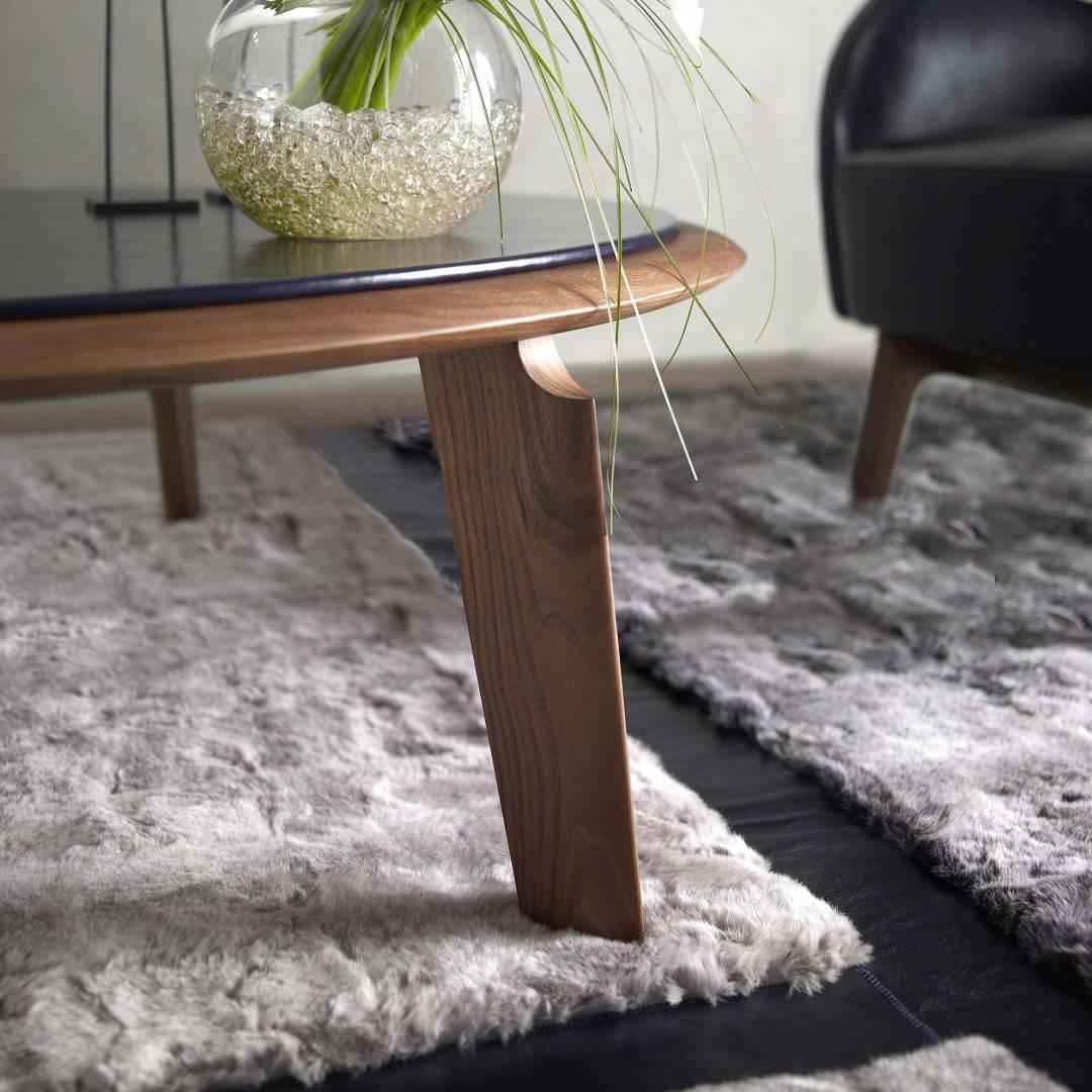 The Bisten coffee table is a luxury. The base is made of wood (American walnut). Round table top with leather (other top options available). A table with three legs. Creates a sense of minimalism and symmetry. Elegant and original addition to your