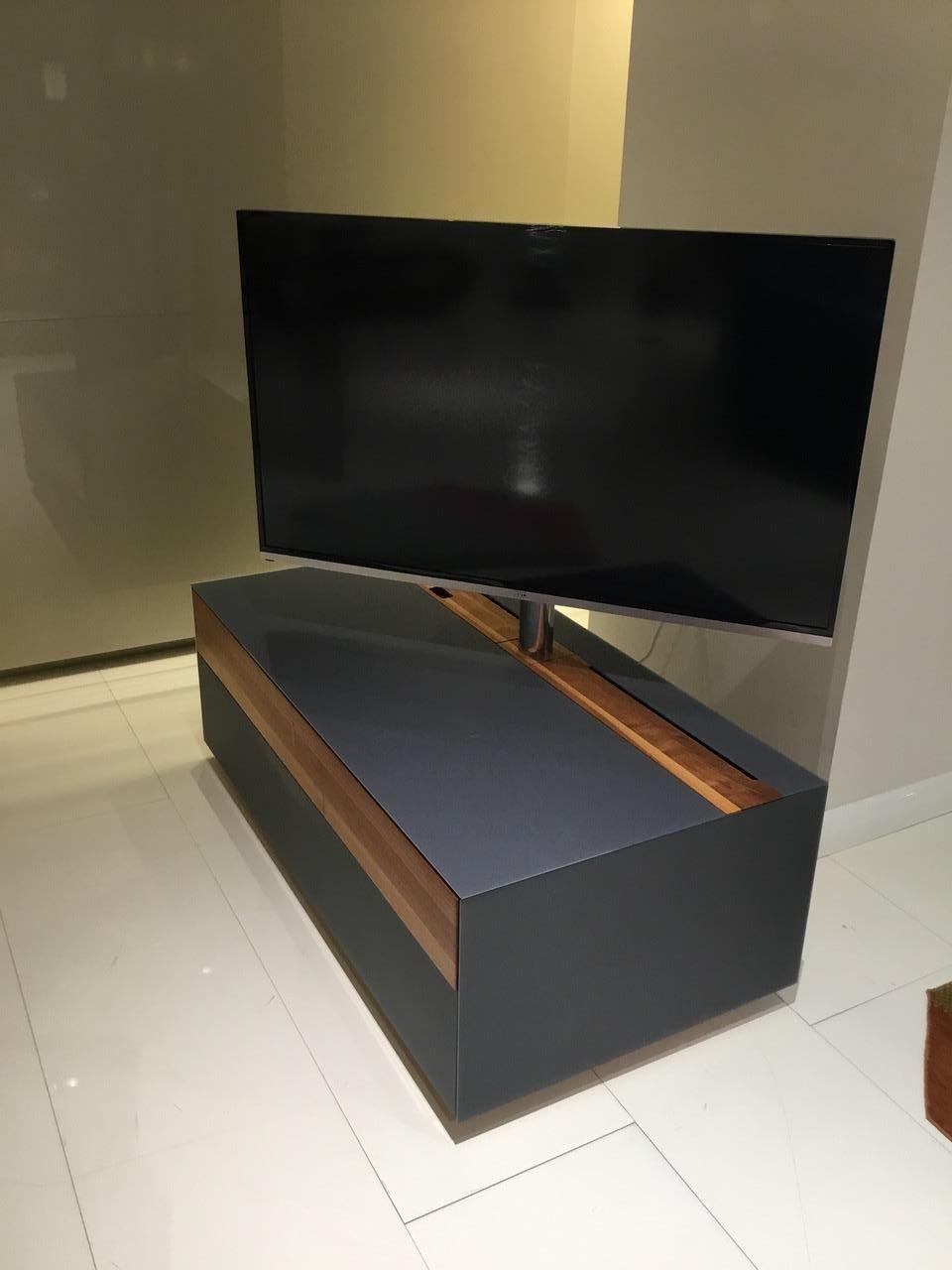 Entertainment center made of walnut and beech wood with matt anthracite glass top and sides. The finished back allows you to place against a wall or floated in the middle of the room as a room divider. 

Shown with a 51