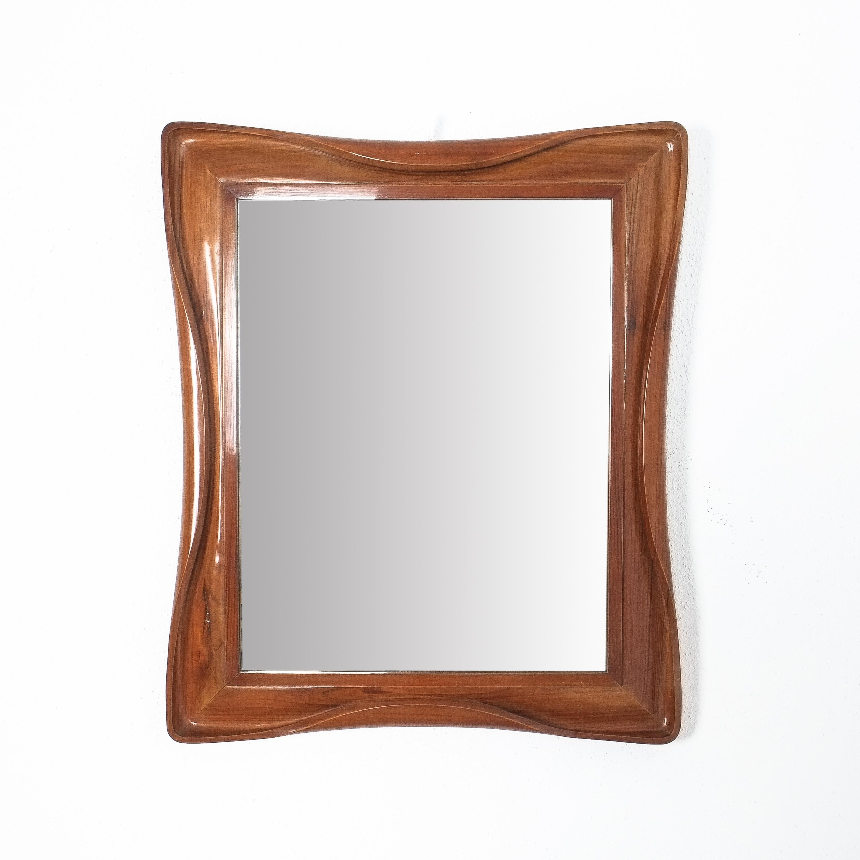Walnut mirror with carved 'folded' edges, Italy, circa 1955

It is in good vintage condition with no damages, the original mirror glass also looks good with no aging stains.
Dimensions: 24.4