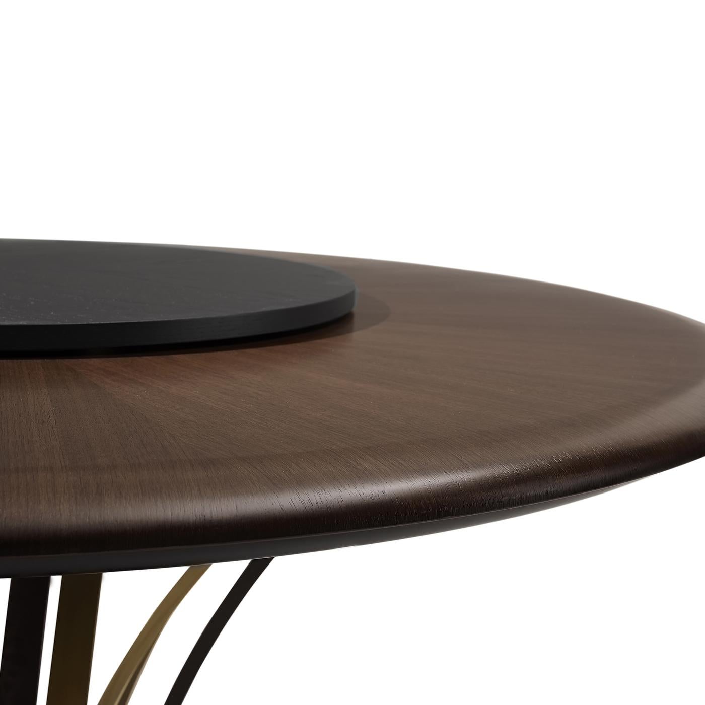 Sculptural and sophisticated, this splendid dining table will make a statement in any modern interior. Boasting a flamed ash-veneered MDF and plywood frame, the large, round top of Canaletto walnut is enriched with halo-shaped inlay work. The
