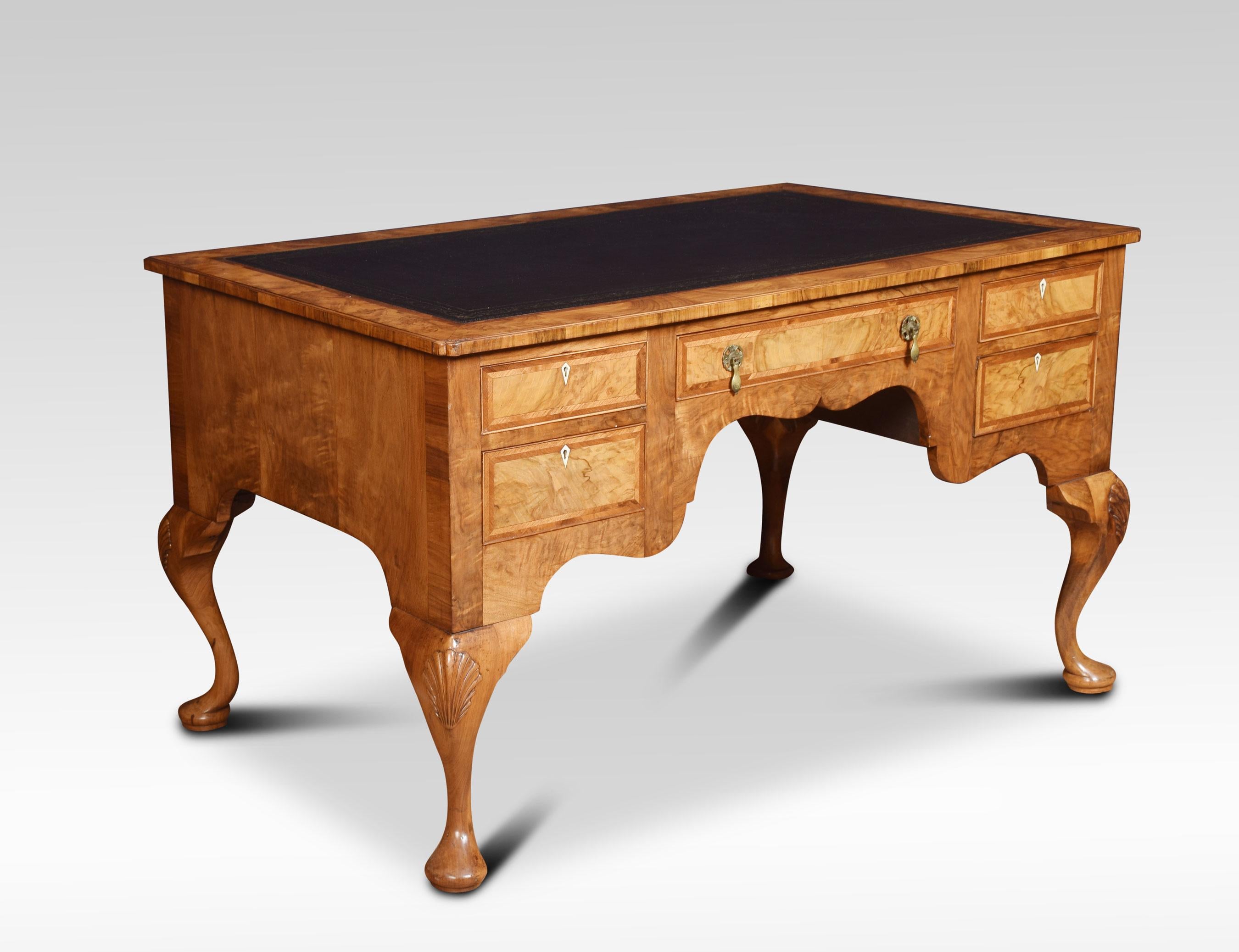 Walnut writing desk, the inset tooled leather writing surface, within a herringbone crossbanded border. Above central frieze drawer flanked by two further drawers to each side. All raised up on shell caped cabriole legs.
Dimensions
Height 31