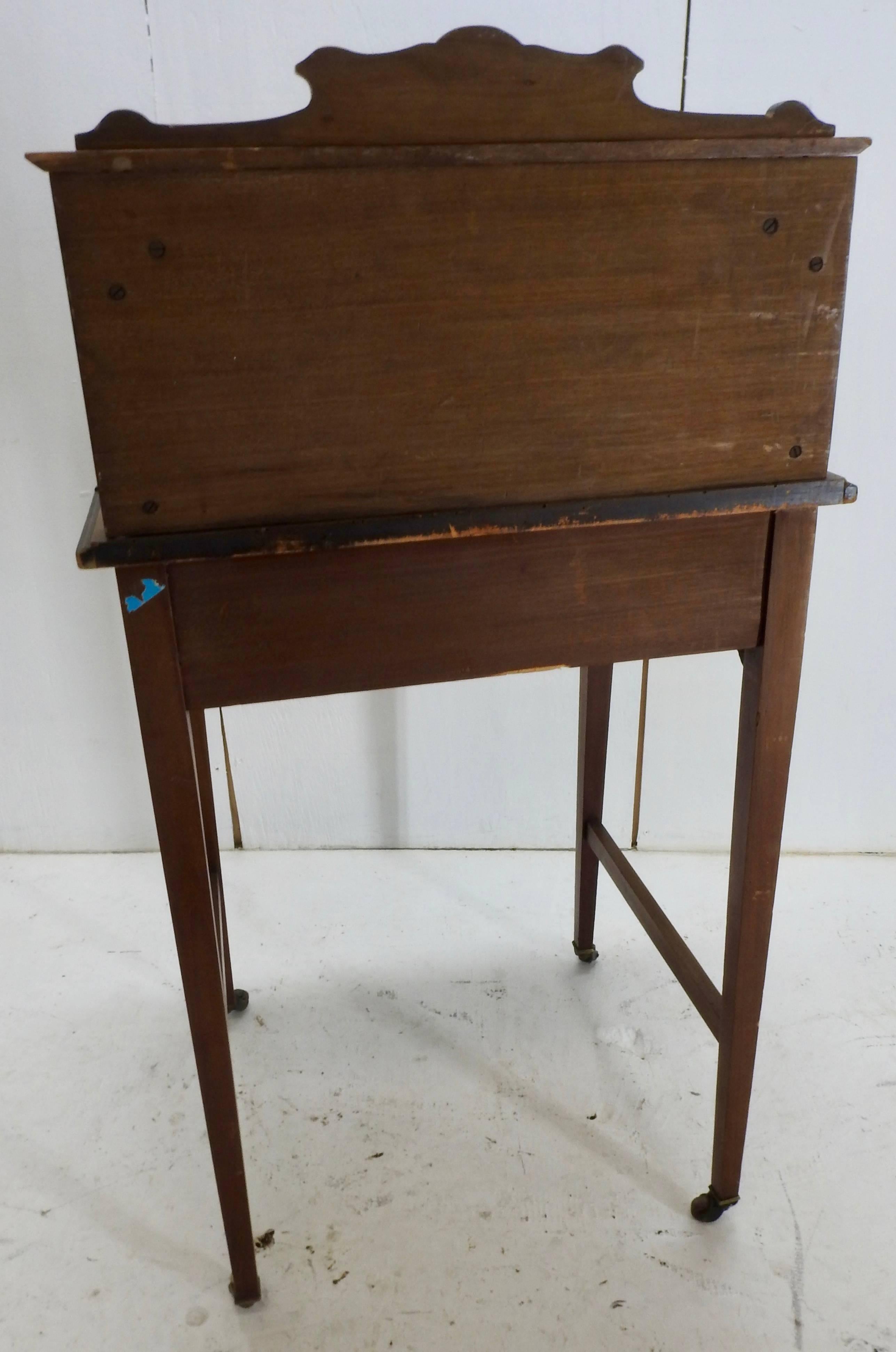 A detailed Victorian lift top writing desk by Manchip and Sons of Bridgewater. Has detailed inlay and gold accents on the leather top. Has makers label attached. The lock is missing. The tag inside has Manchip & Sons Bridgewater.