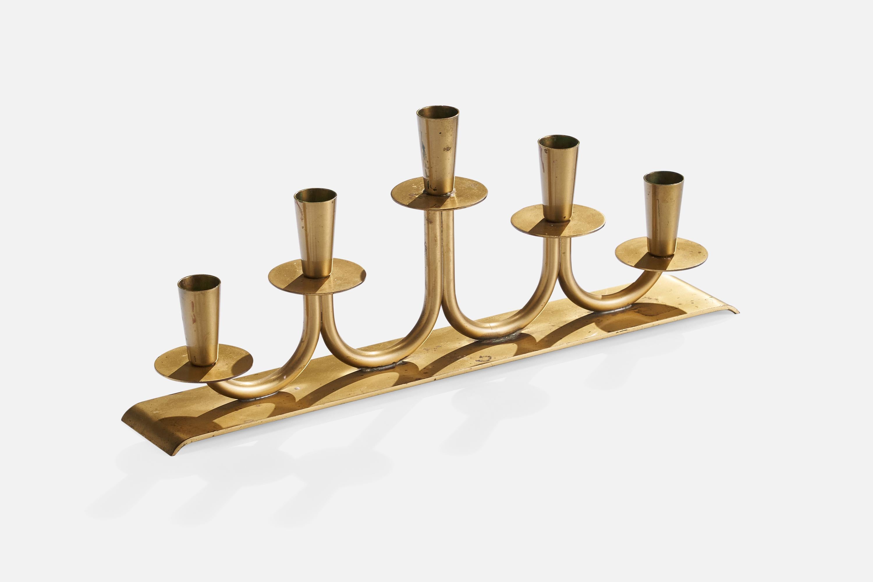 A brass candelabra designed by Walter Andersson and produced by Ystad-Metall, Sweden, c. 1950s.

Holds .8” candles.