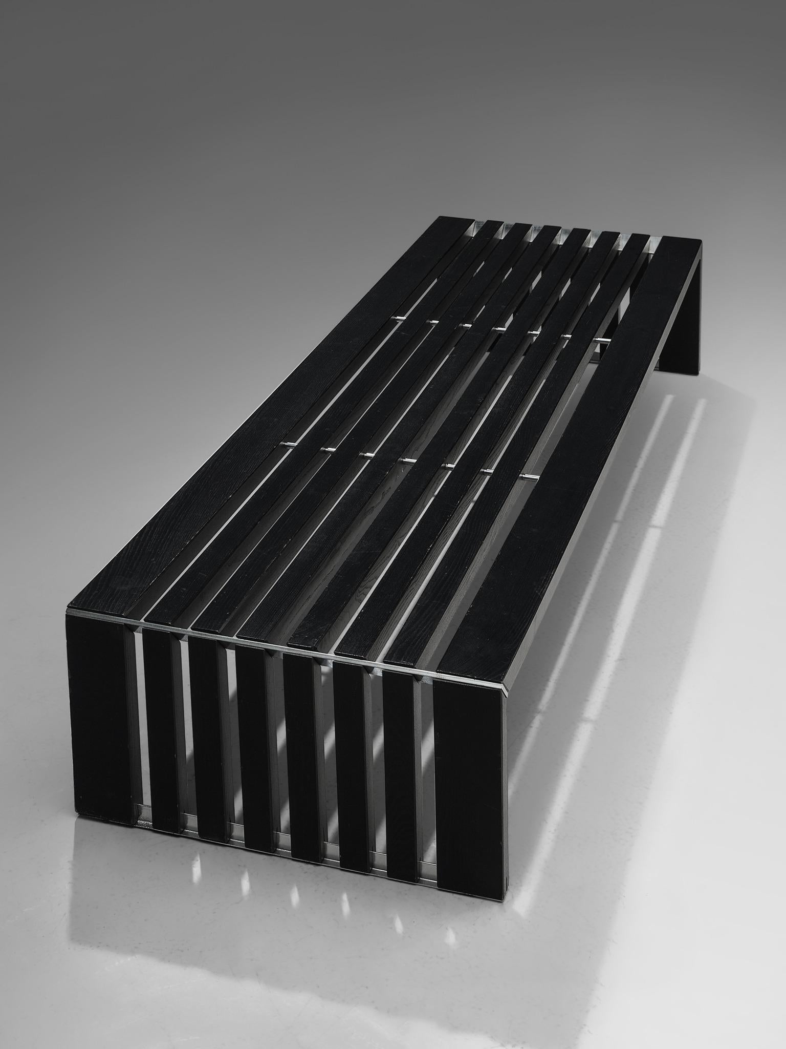 Walter Antonis for 't spectrum, slat bench, black lacquered oak and metal, The Netherlands, 1969. 

Low bench in lacquered black oak, mounted together by metal fixtures. The structure of the bench is solid and heavy, making it a good fit for a