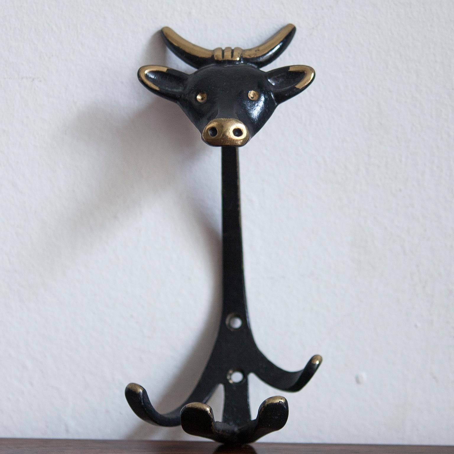 A set of 6 Austrian modernist brass wall coat hooks, displaying a cow, a monkey, a dog, a cat, a donkey and a gnome. A very humorous design by Walter Bosse, executed by Hertha Baller Austria in the 1950s. Made of black finished brass. In very good