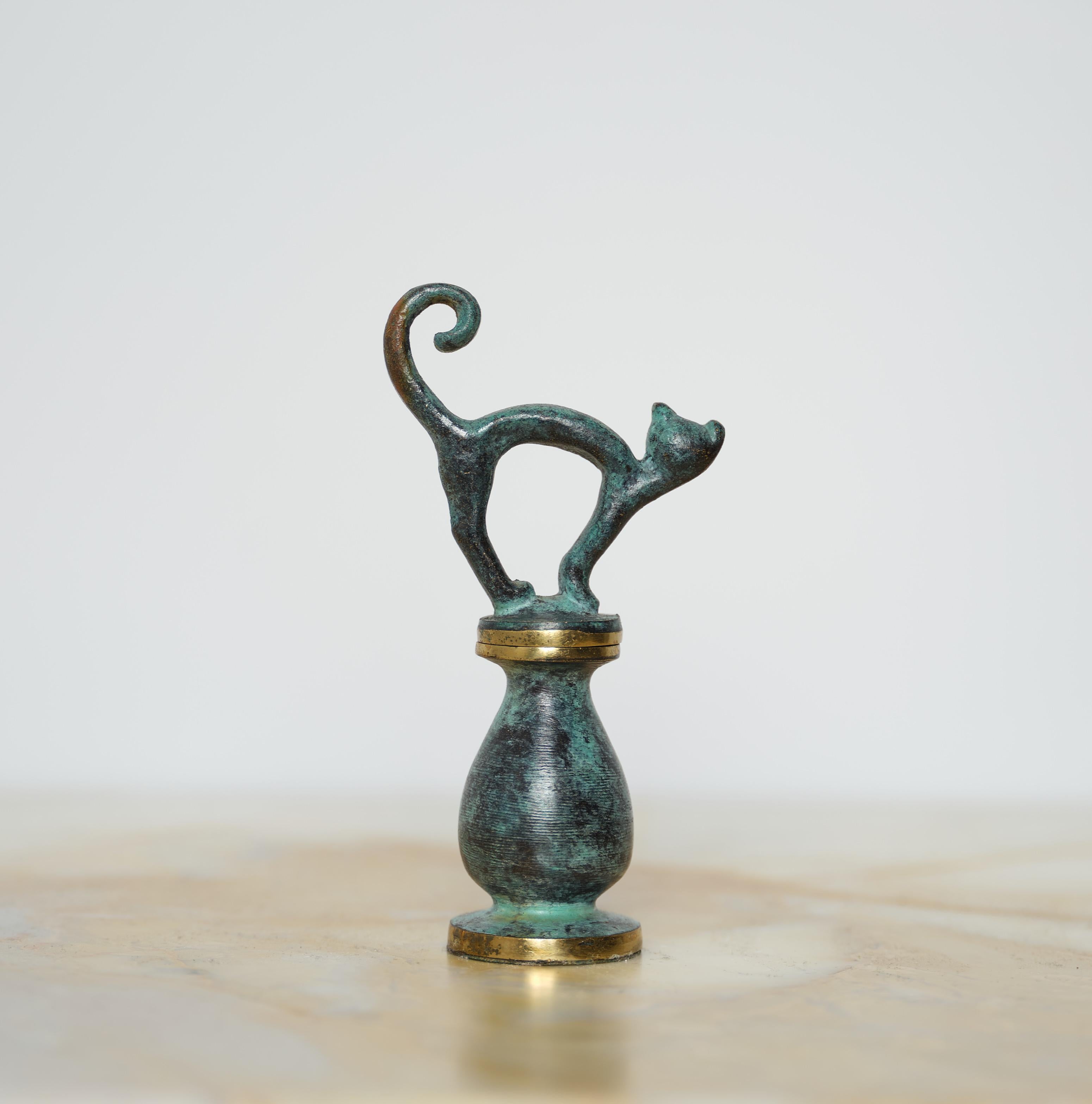 Delight in the whimsy and functionality of this unique brass corkscrew, crafted in the 1950s by renowned designer Walter Bosse. Made in Vienna, Austria, this charming piece showcases Bosse's signature playful design, shaped into a stylized cat that