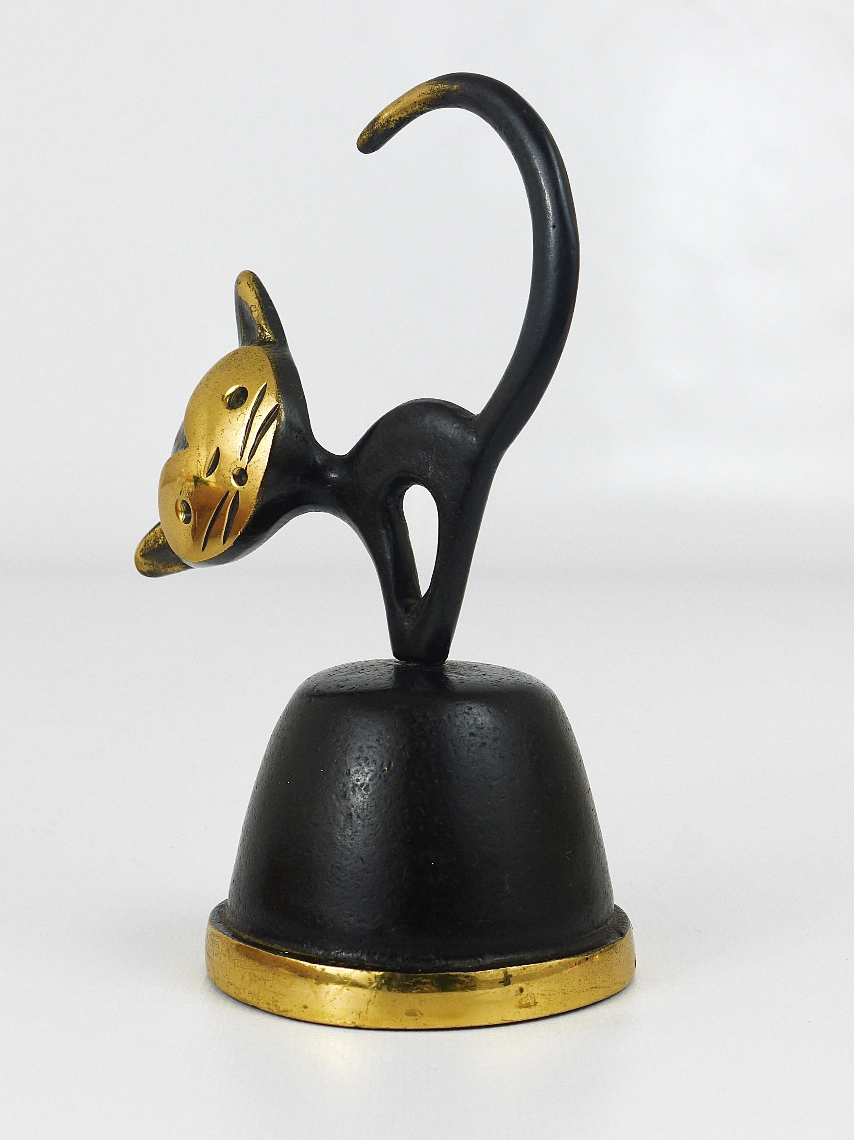 A charming midcentury table bell displaying a cat. A very humorous design by Walter Bosse, executed by Herta Baller Austria in the 1950s. Made of brass, in very good condition.