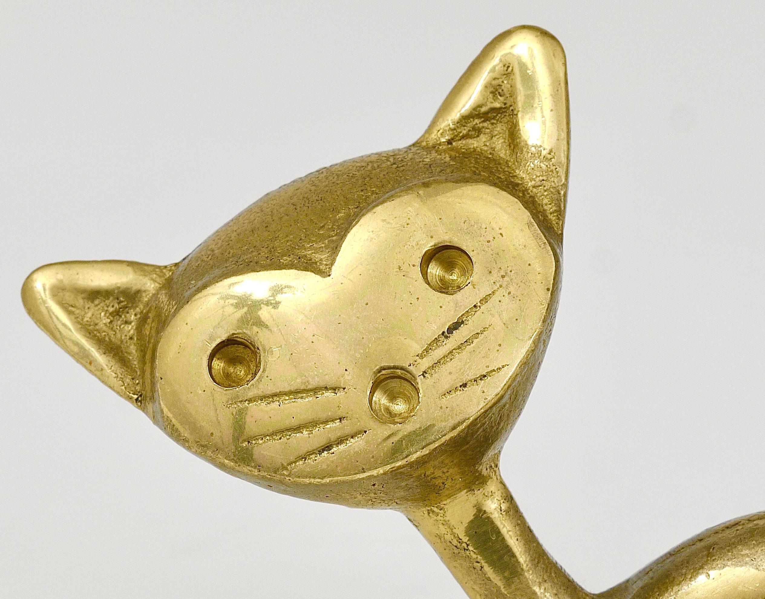 A very charming Austrian midcentury pen or pencil holder, displaying a cat. A very humorous design by Walter Bosse executed by Hertha Baller Austria in the 1950s. Made of brass in very good condition with charming patina.