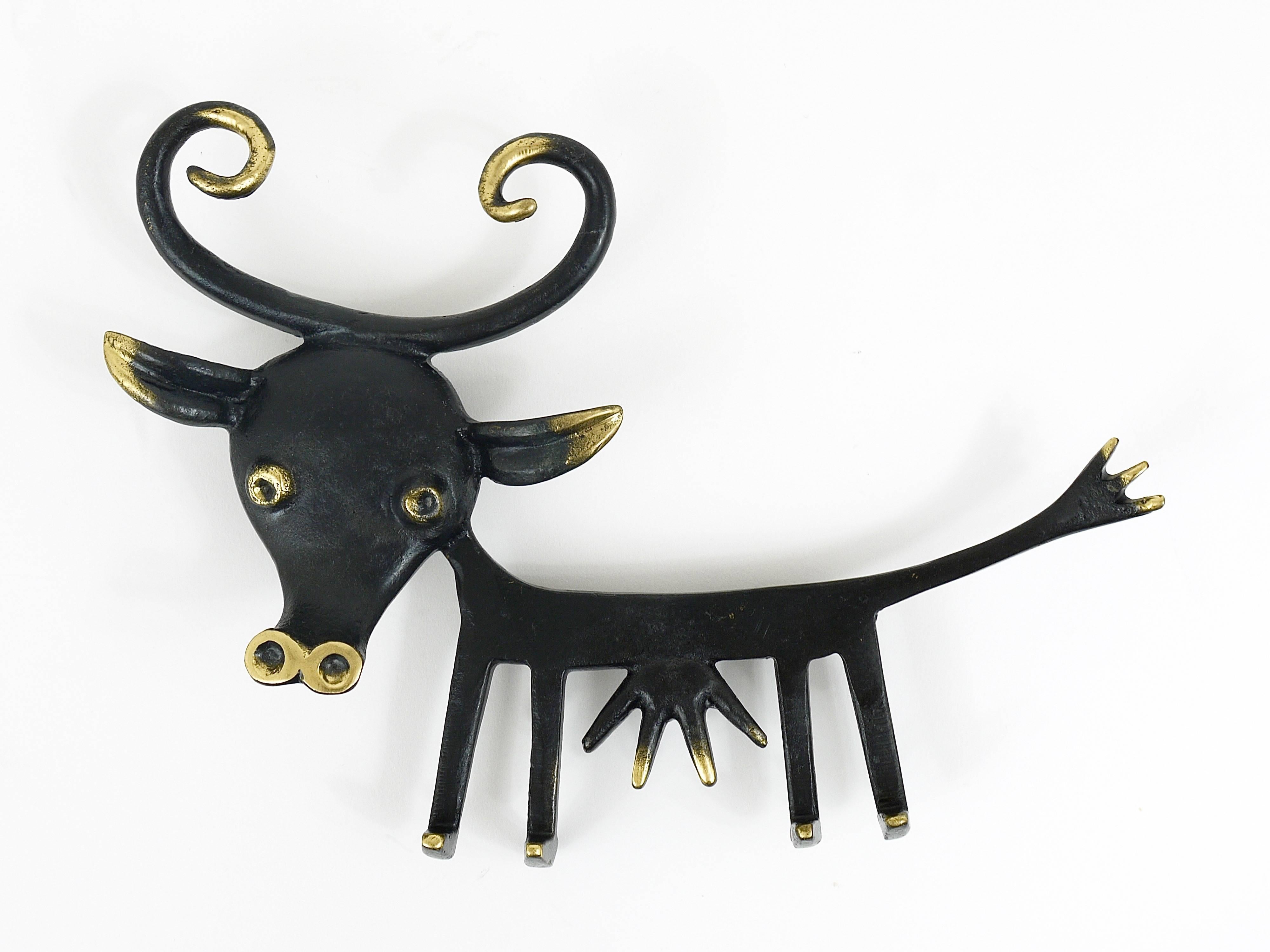 A charming and rare key holder, displaying a funny looking cow. Very large. A humorous design by Walter Bosse, executed by Herta Baller, Austria in the 1950s. Made of brass, in excellent condition.