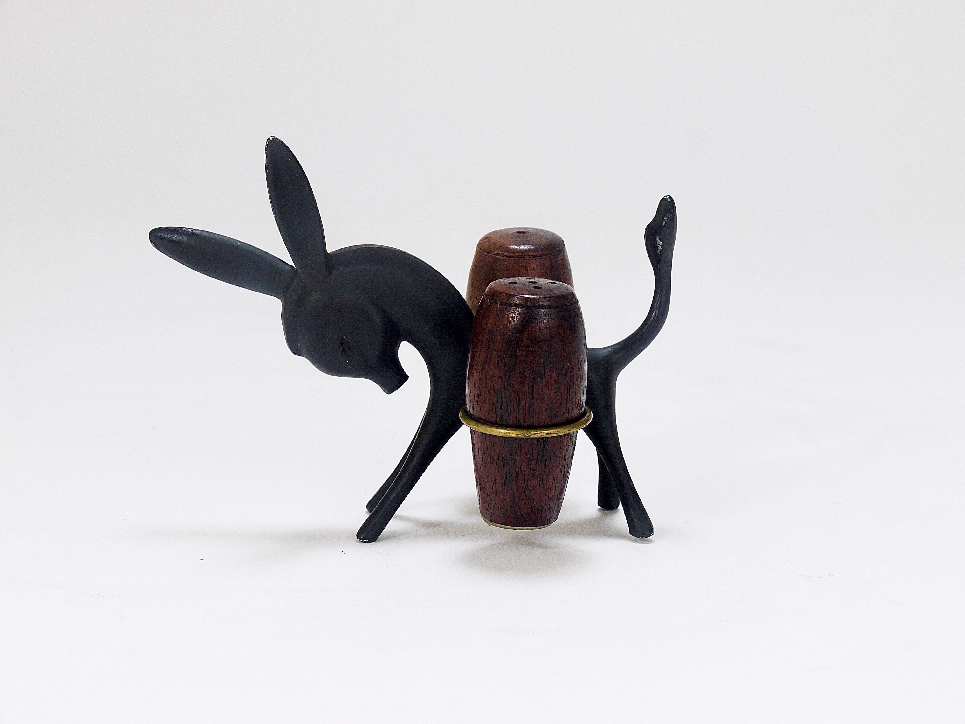 A charming Austrian midcentury Shaker set, displaying a donkey carrying two wooden barrels. A humorous design by Walter Bosse, executed by Hertha Baller Austria in the 1950s. The donkey is made of blackened metal and brass, the barrels are made of