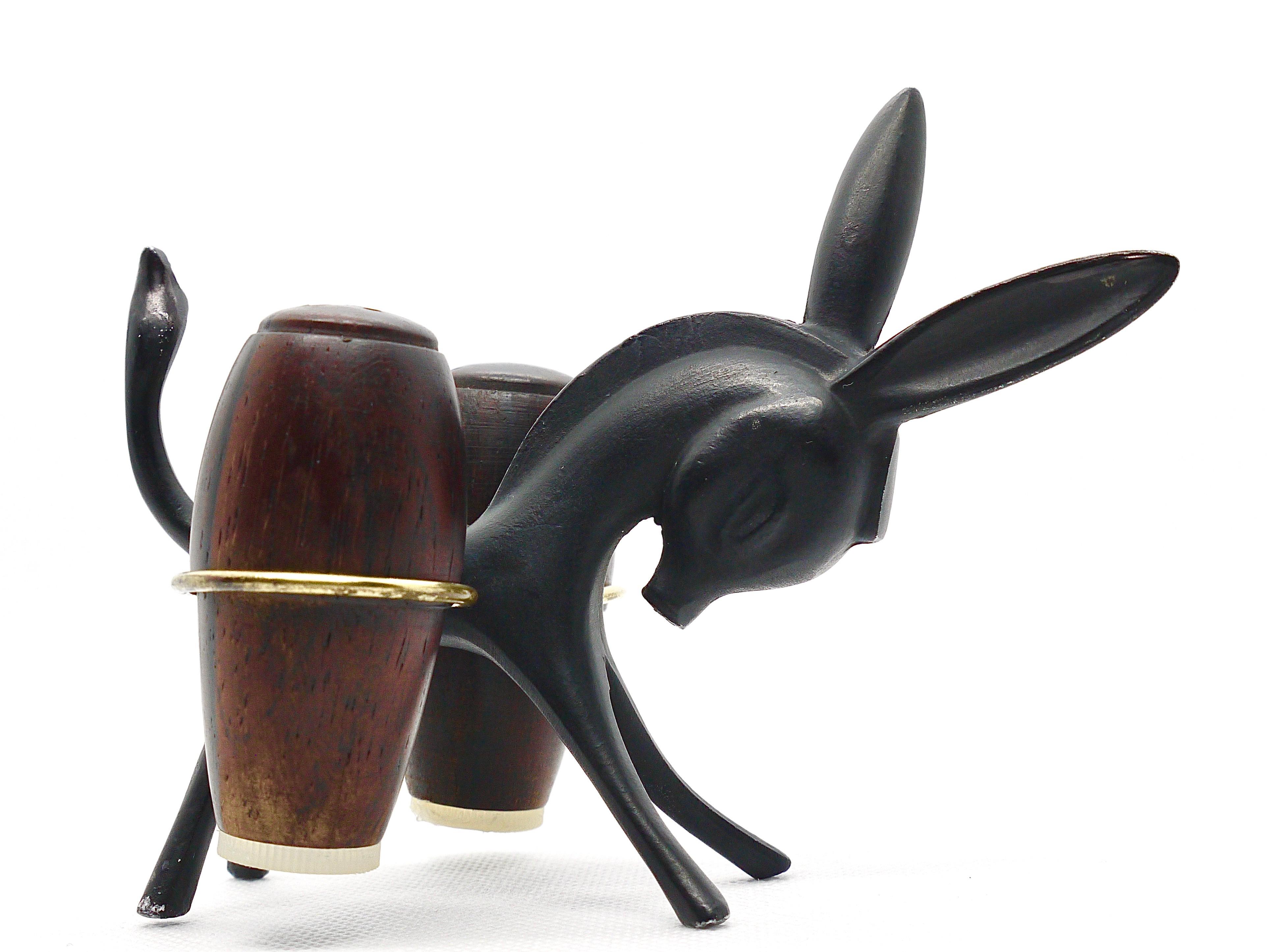A charming Austrian midcentury Shaker set, displaying a donkey. A very humorous design by Walter Bosse, executed by Hertha Baller Austria in the 1950s. Made of metal and walnut wood. In very good condition with marginal patina.