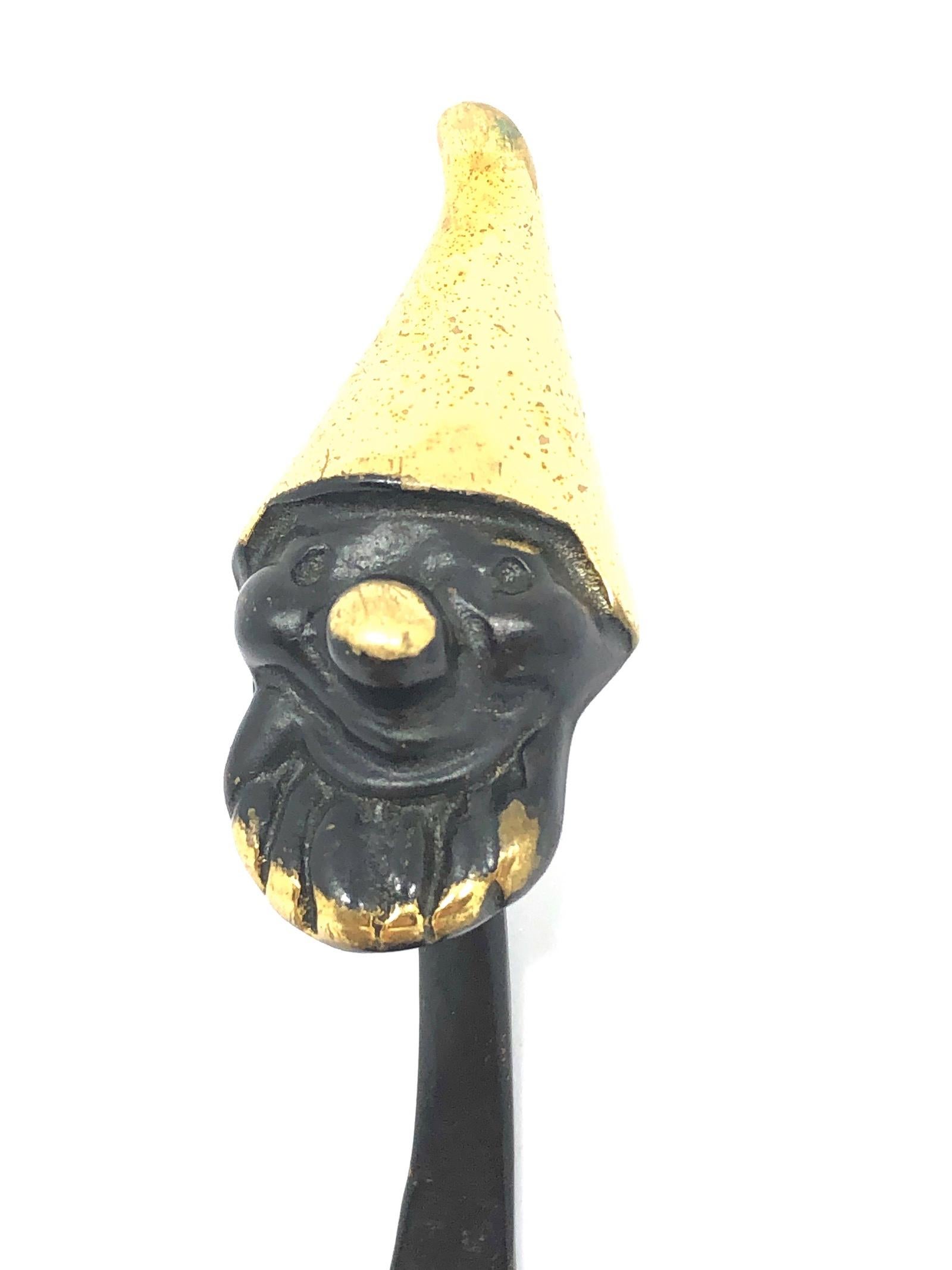 A midcentury brass wall coat hook, displaying a dwarf. A humorous design by Walter Bosse, executed by Hertha Baller Austria in the 1950s. Made of black finished brass. In very good condition. The hook has a height of 7