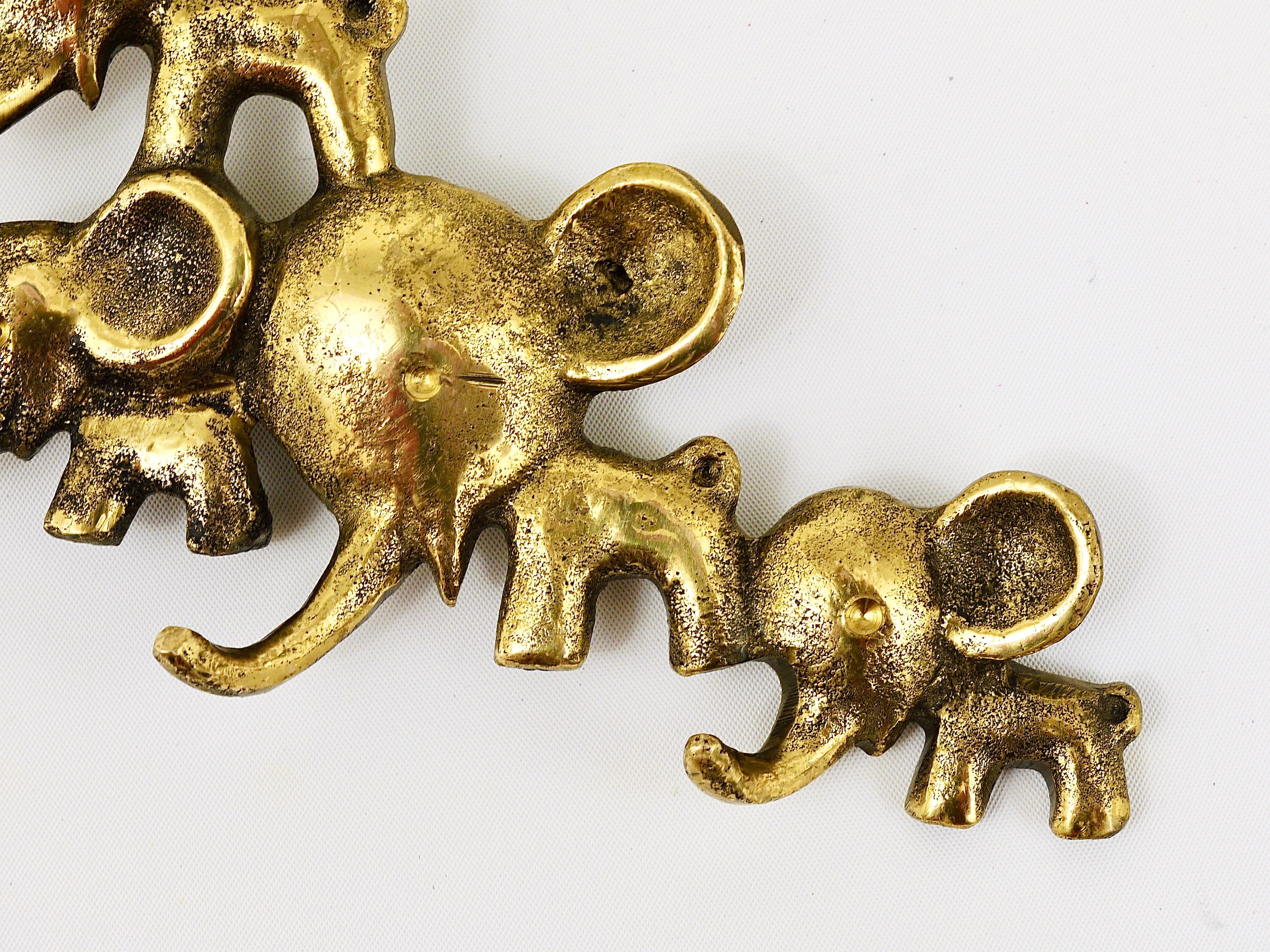 A charming and rare key holder, displaying five elephants in different sizes. A very humorous design by Walter Bosse, executed by Herta Baller, Austria, in the 1950s. Also suitable as a towel holder or for dish towels in the kitchen. Made of brass,