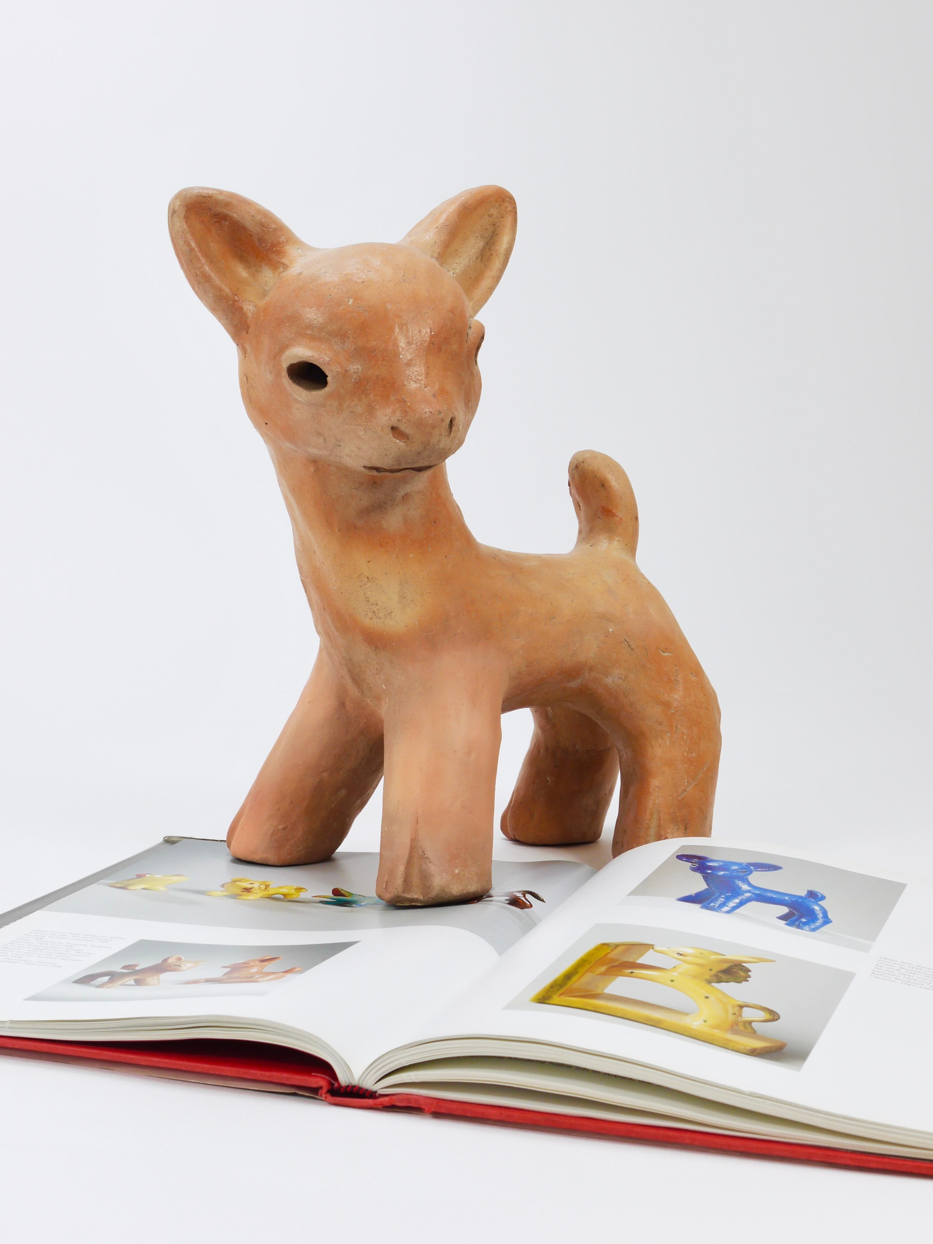A charming and large handmade figurine / statue depicting a baby deer / fawn. Originally designed as a doorstop by Walter Bosse and manufactured between 1924 and 1936 in Kufstein, Tyrol, Austria. Handmade from ceramic / terracotta, it is in good