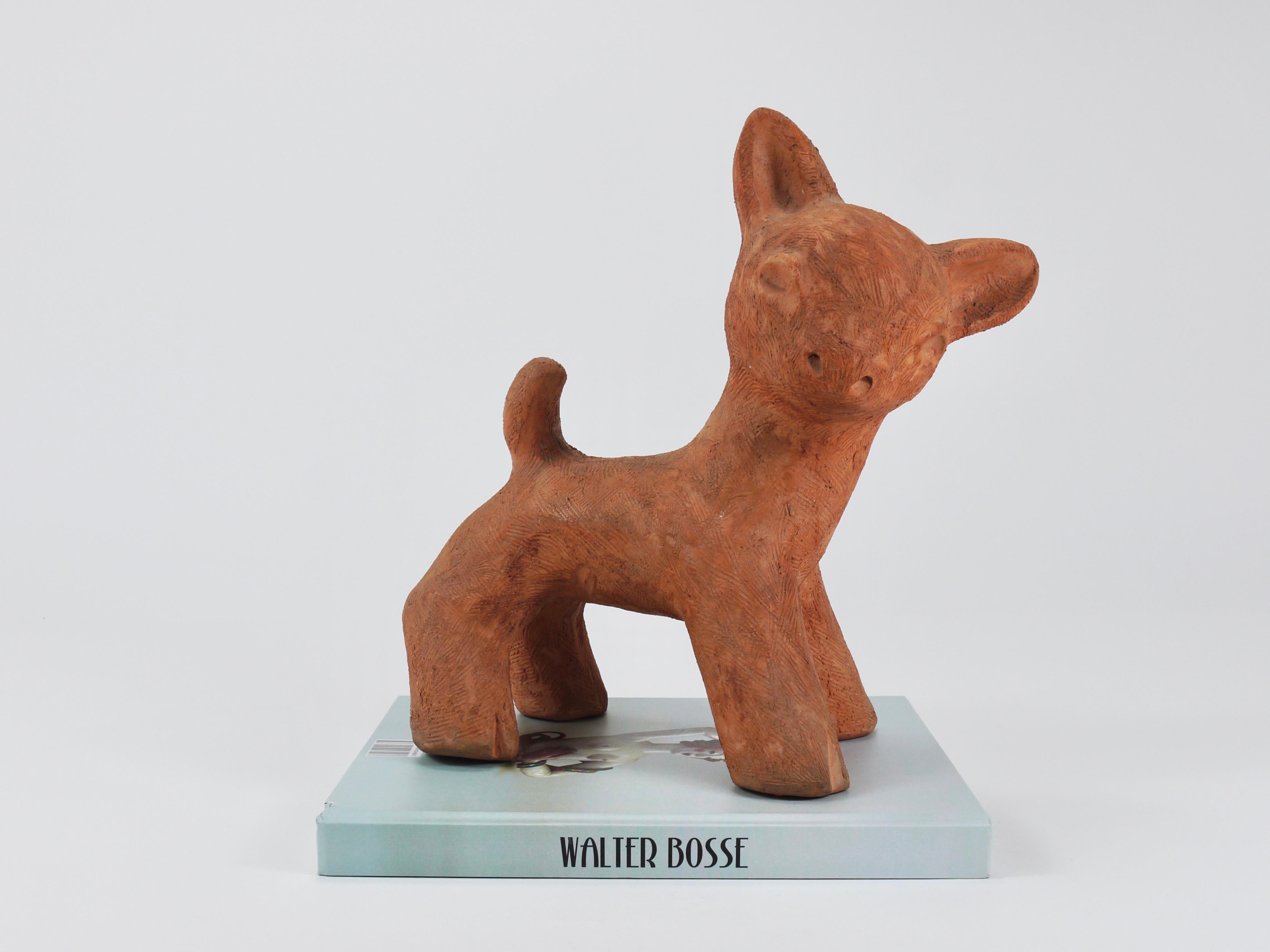 A charming and large handmade figurine / statue depicting a baby deer / fawn. Originally designed as a doorstop by Walter Bosse and manufactured between 1924 and 1936 in Kufstein, Tyrol, Austria. Handmade from ceramic / terracotta, it is in good