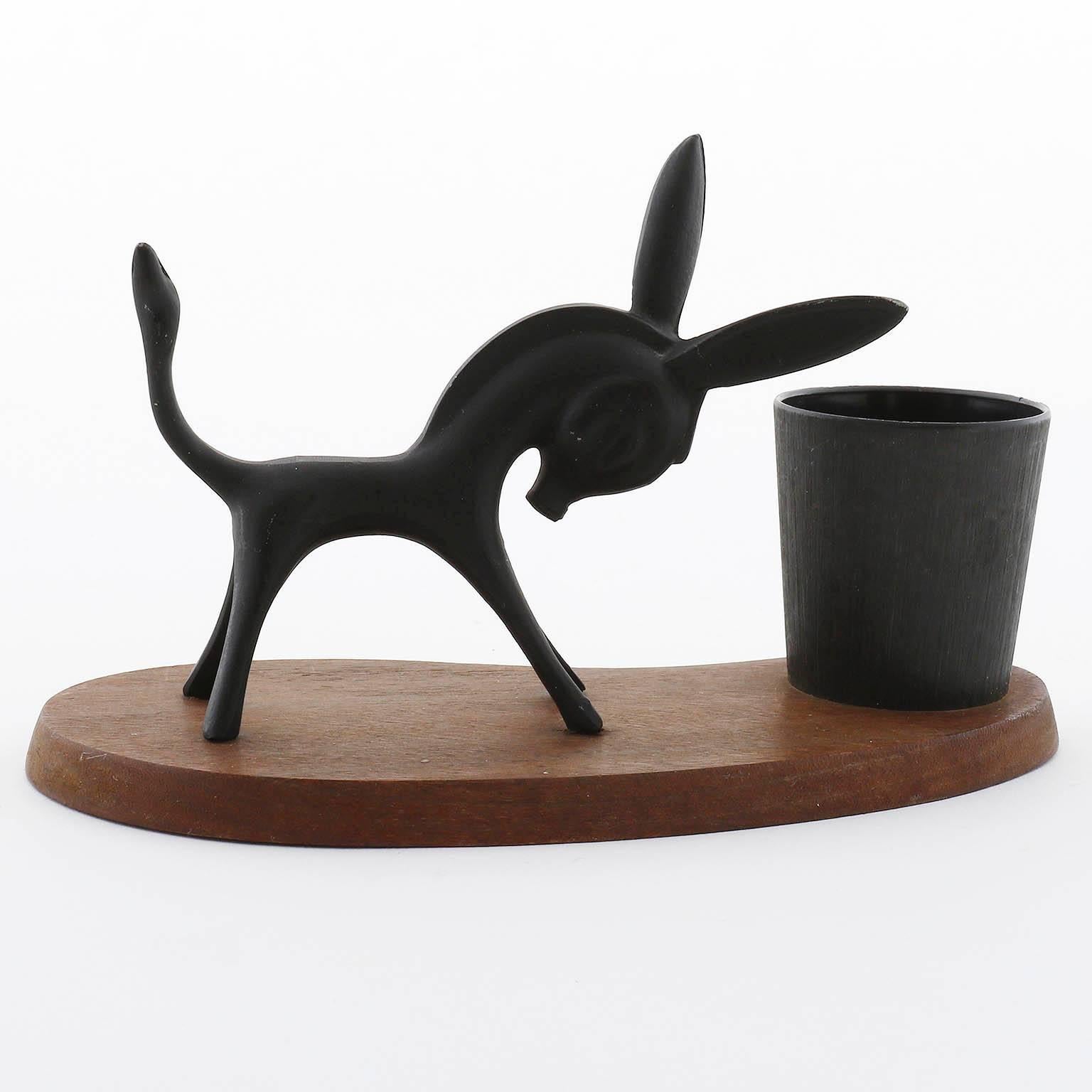 A penholder in the form of a donkey or horse by Walter Bosse, Vienna, 1950s.
It is made of blackened brass and a wooden base.