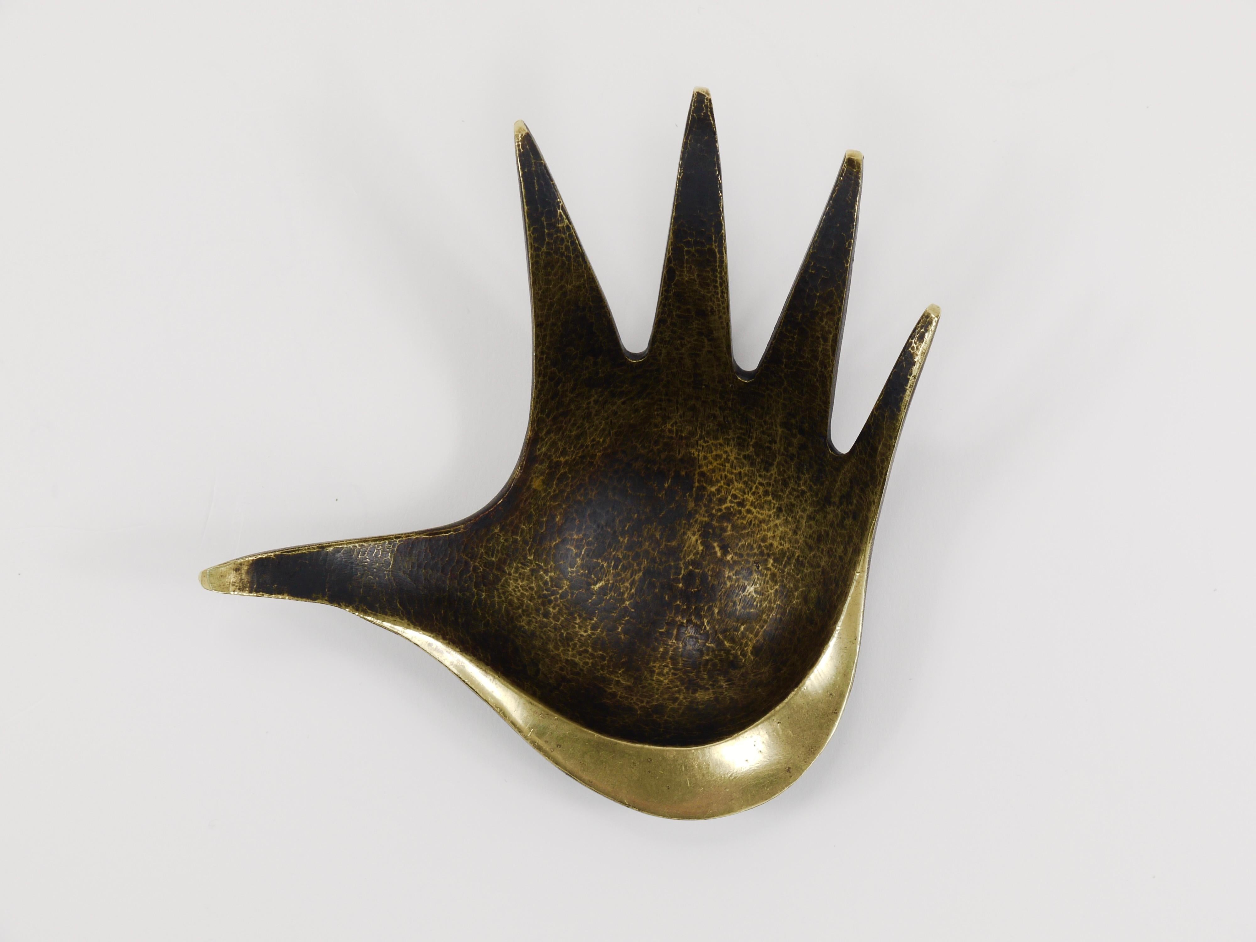A beautiful mid-century sculptural brass bowl designed in the shape of a hand. Originally conceived as an ashtray, this elegant brass piece is versatile to be used as a jewelry bowl, ring holder or a stylish 