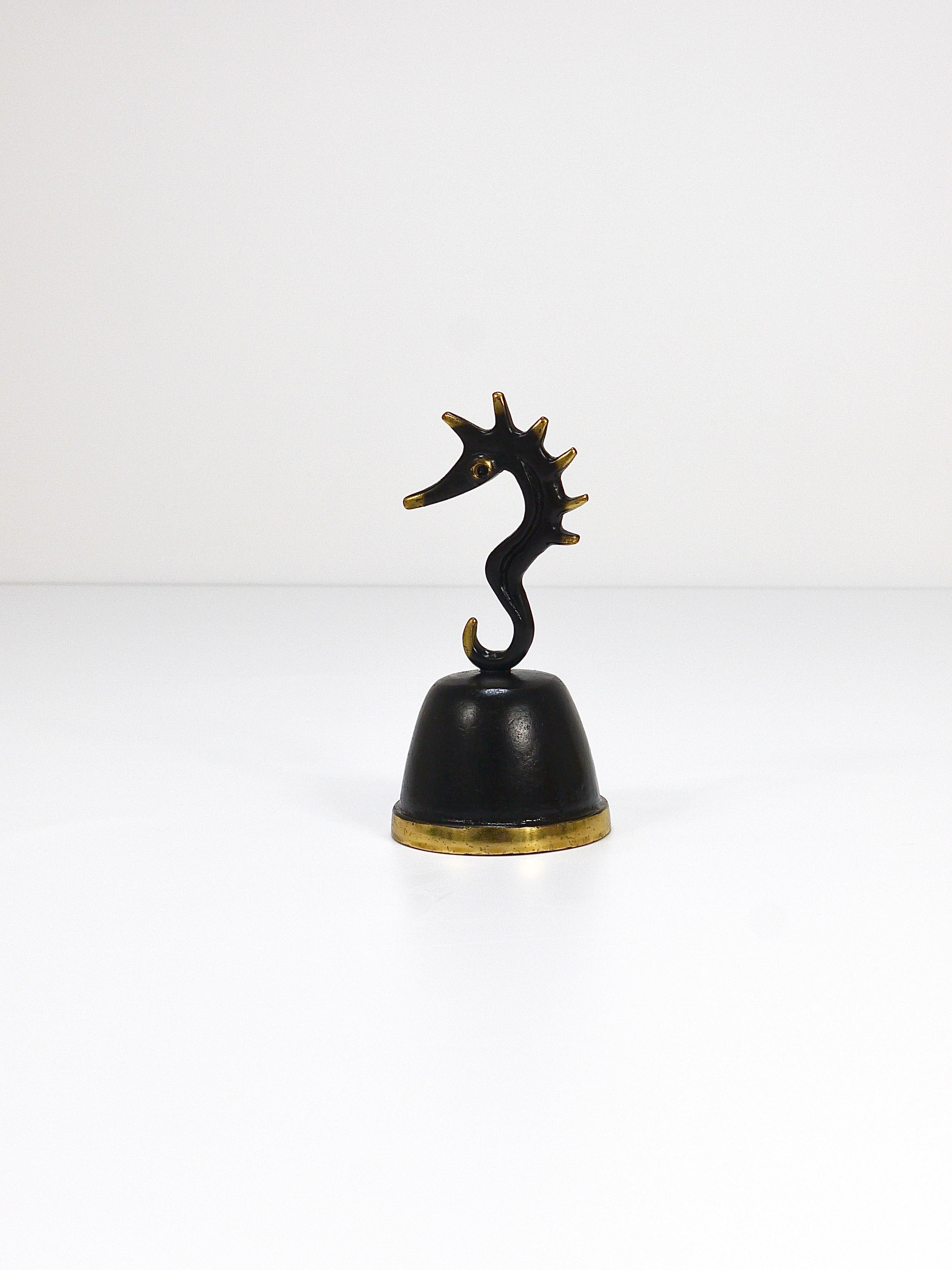 A charming sculptural table dining bell, displaying a cute seahorse. A humorous design by Walter Bosse, executed by Hertha Baller Vienna, Austria in the 1950s. Made of brass, in very good condition with marginal patina. The bell has a wonderful