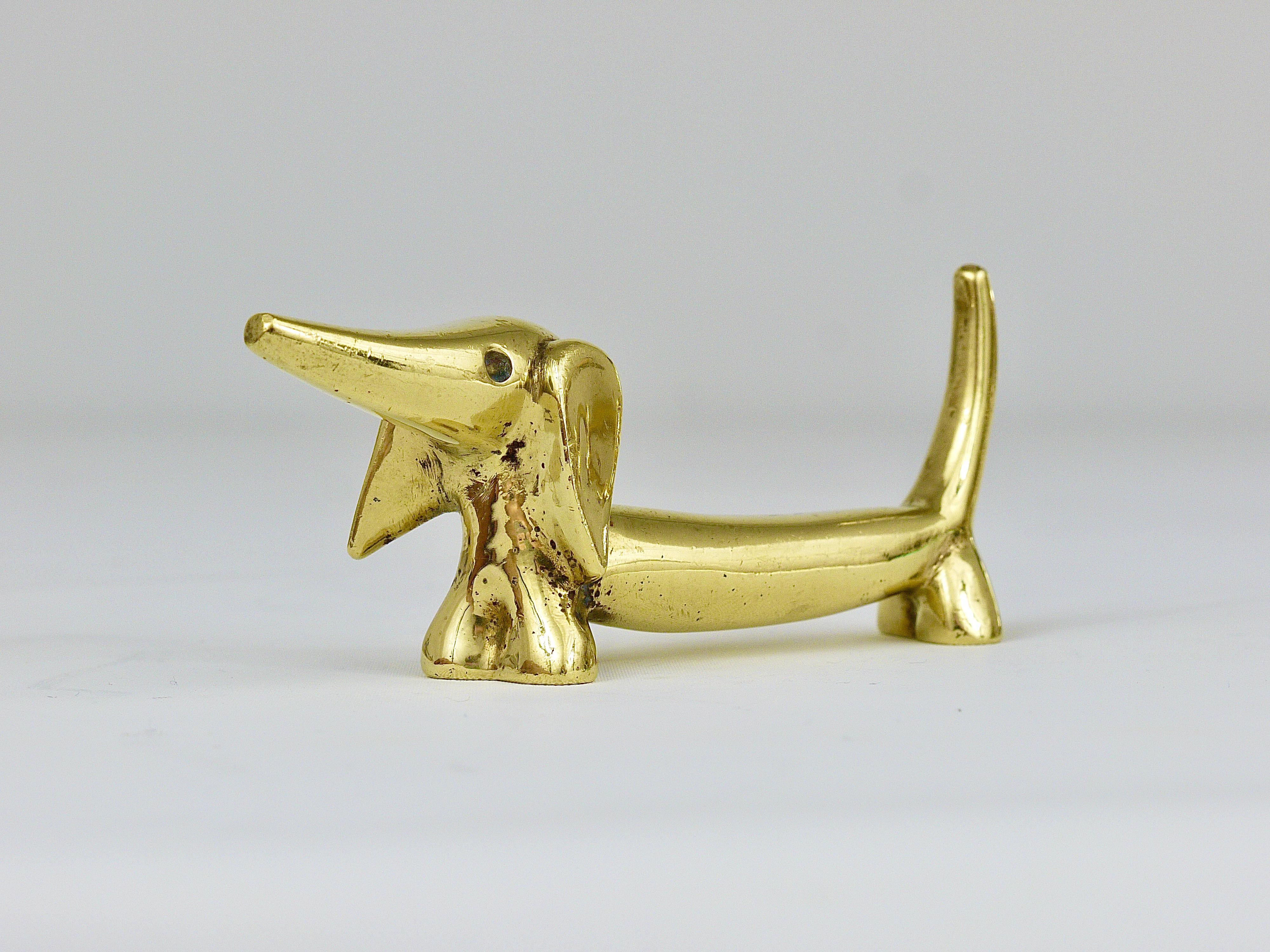 A lovely sausage dog sculpture made of brass from the 1950s. Designed by Walter Bosse, executed by Hertha Baller. In good condition with charming patina.