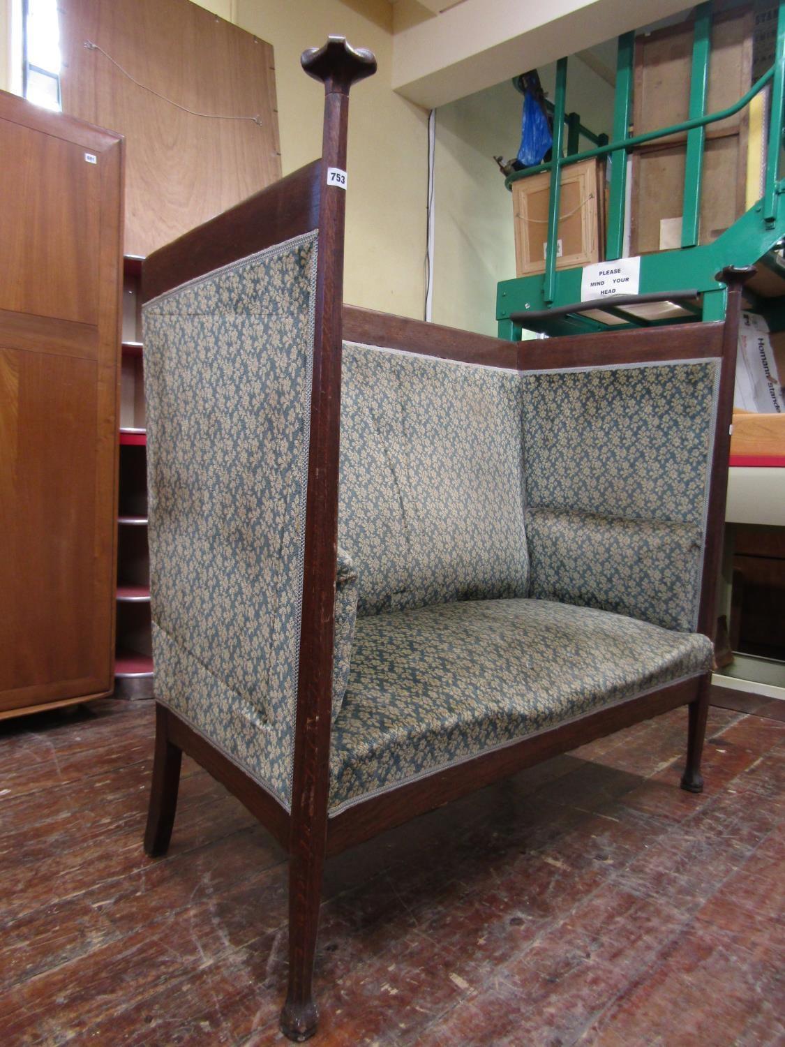 Walter Cave, made by R Nash.
A rare Arts and Crafts exhibition style oak settee or settle with Voysey style uprights to the front with carved flower head caps. 
A single armchair variation of this settle designed by Walter Cave and made by R Nash