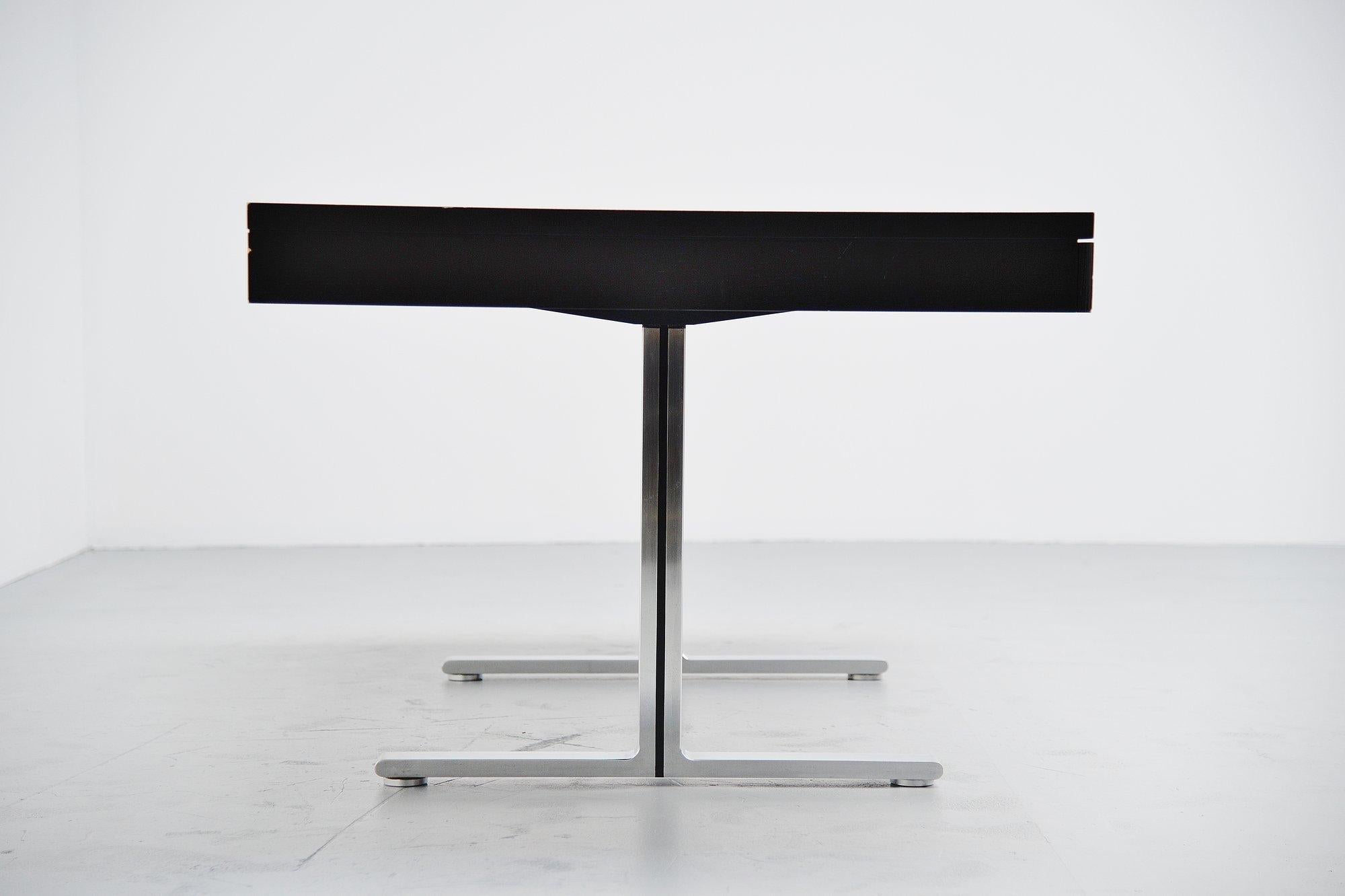 Beautiful large executive desk from the Art collection series designed and manufactured by Walter Knoll, Germany, 1970. Black stained ash wooden desk, with black leather inlay, 2 cm thick flat stainless steel T shaped feet. This desk is all about