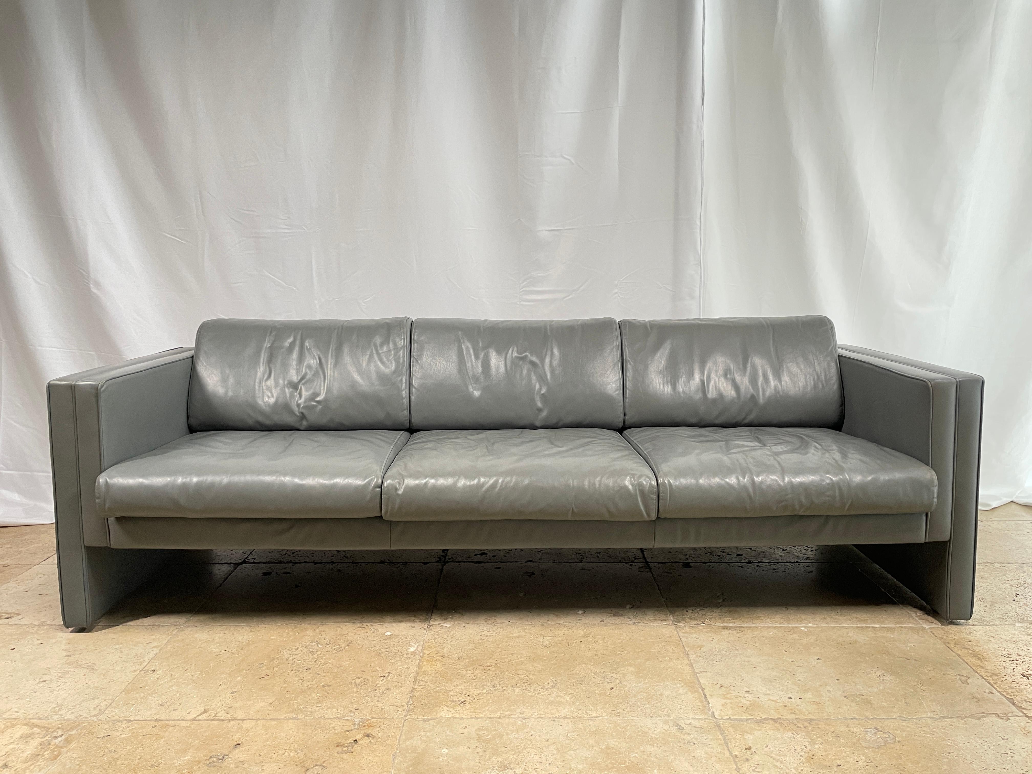 Jürgen Lange 
 Three-seater sofa by Jürgen Lange; fully covered in grey full-grain leather model Studio 190 
 Edited by Walter Knoll, circa 1980
Very good conditions, one of the pillow are more tired ( see picture ), but the leather is in good