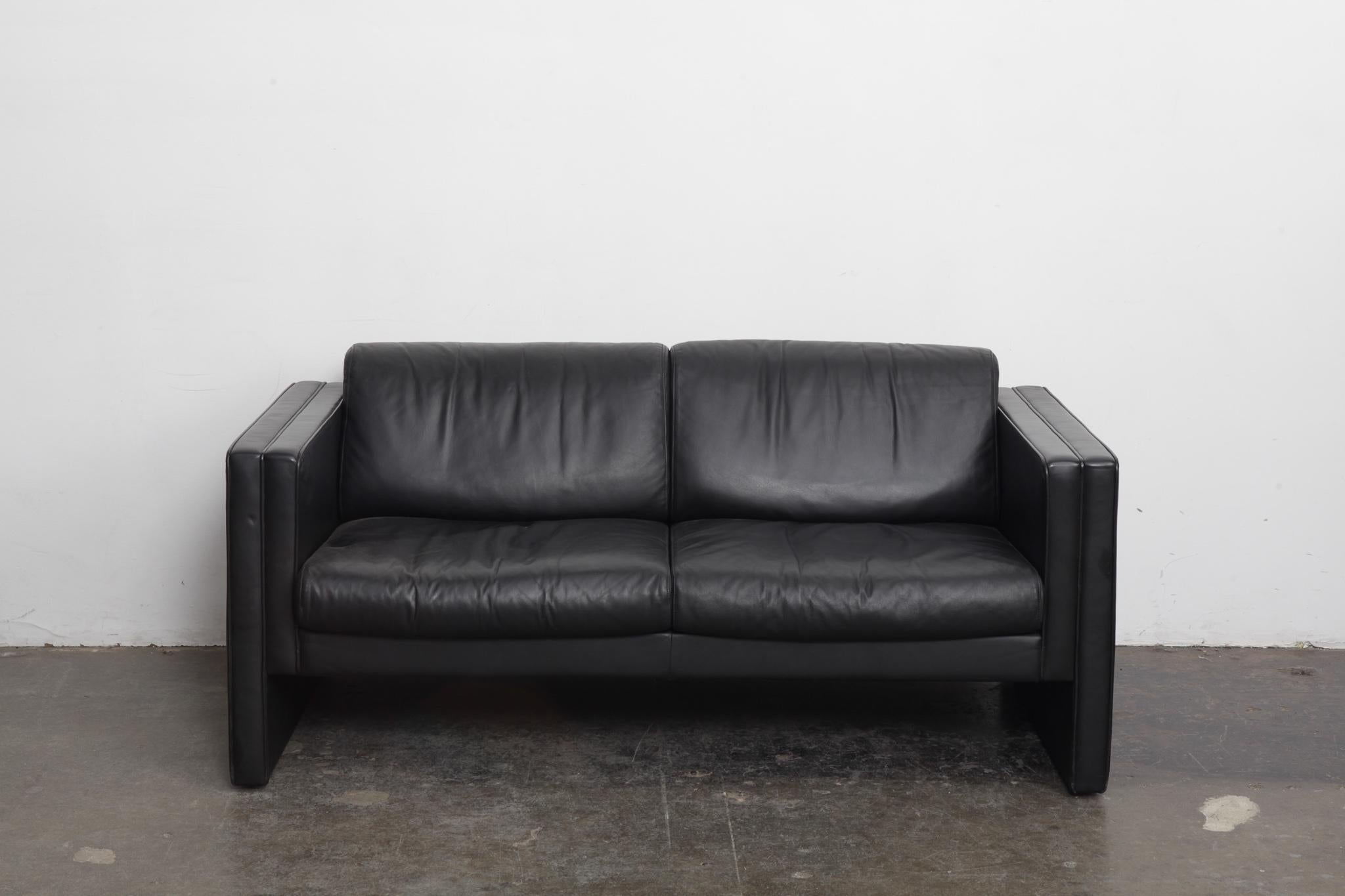 2 seat black leather sofa in original leather, model Studio 190, designed by Jürgen Lange and produced by Walter Knoll, Germany, 1975 as part of their Studio Line Series. Measures: Seat depth is 19.5”.